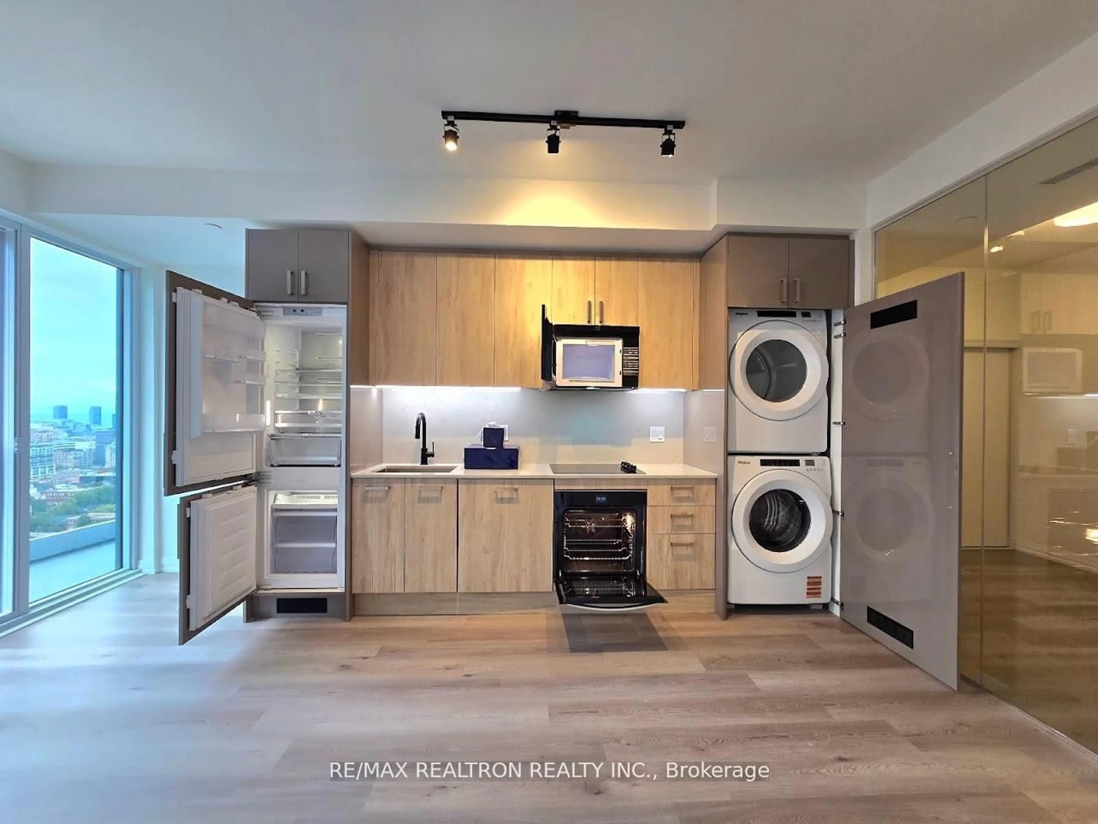 Kitchen with laundary machines, wood/laminate floor for 280 Dundas St #2509, Toronto Ontario M5T 0E3