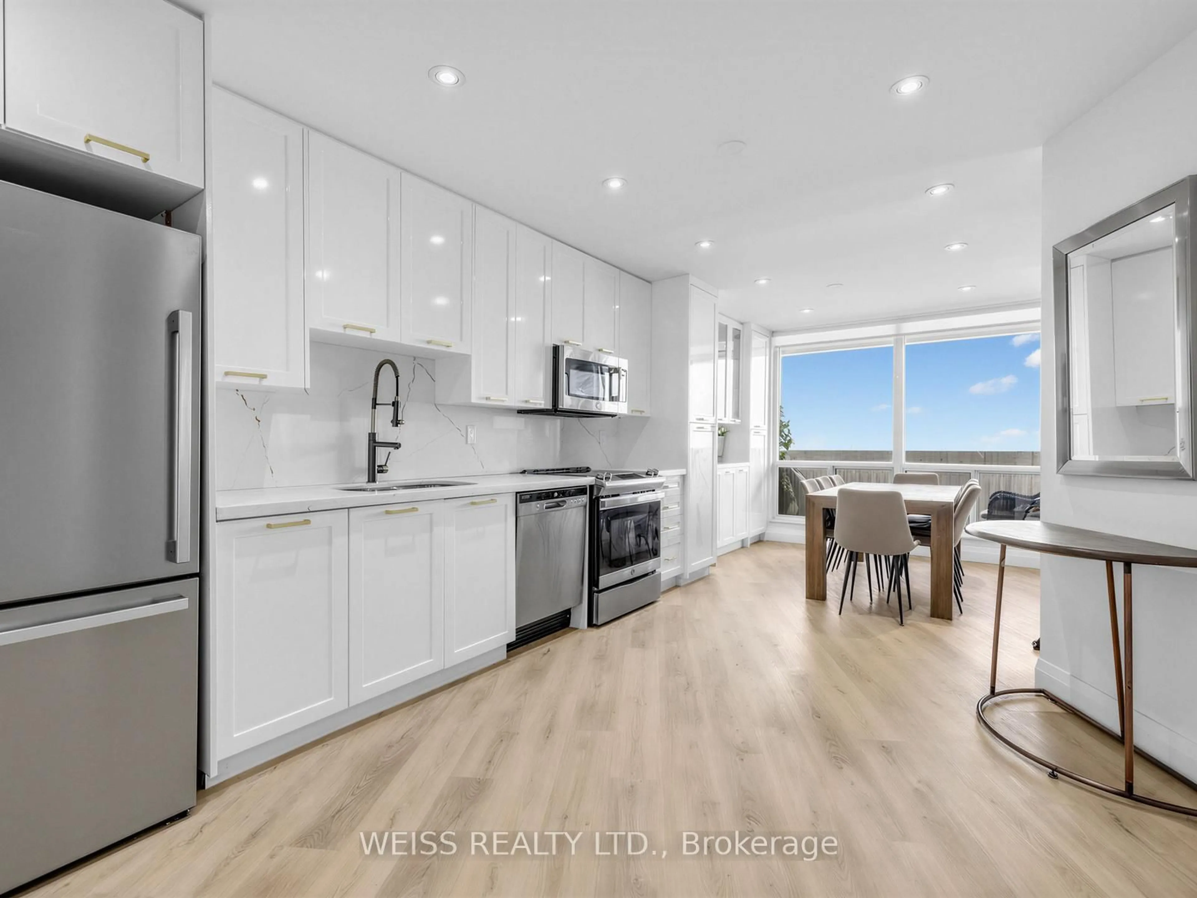 Open concept kitchen, wood/laminate floor for 150 Neptune Dr #1405, Toronto Ontario M6A 2Y9