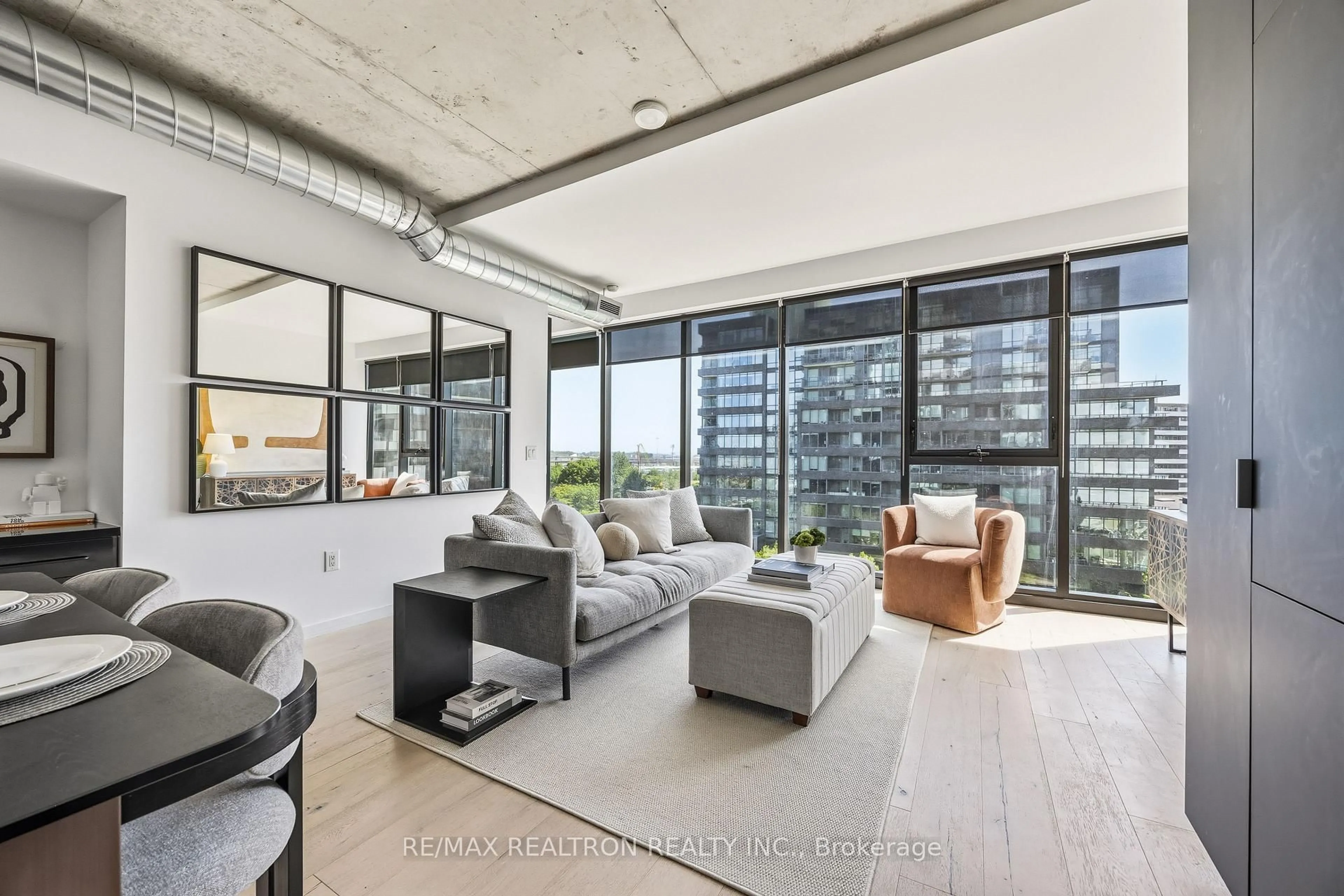 Living room with furniture, cement floor for 170 Bayview Ave #603, Toronto Ontario M5A 0M4