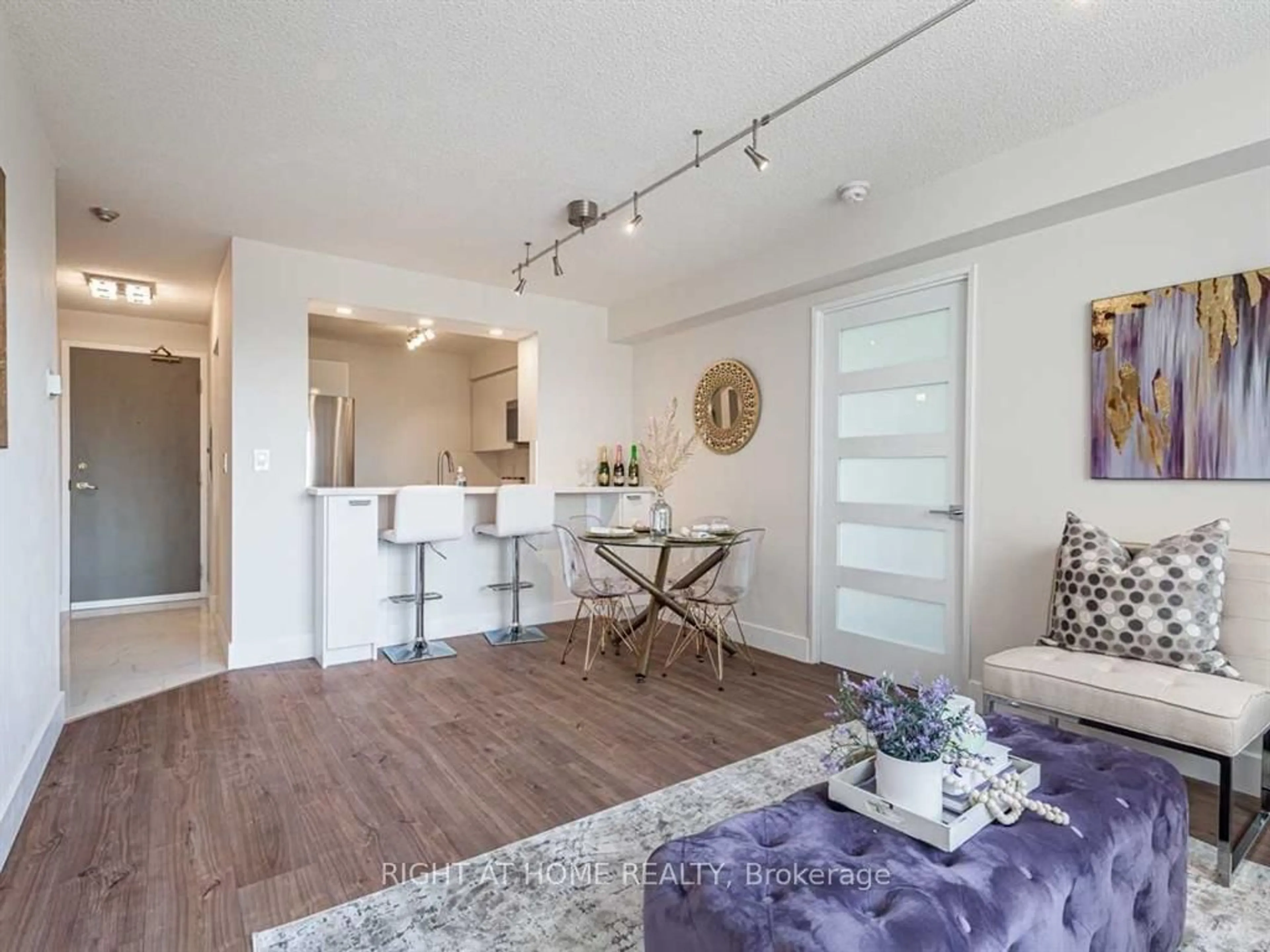 Living room with furniture, wood/laminate floor for 555 Wilson Hts Blvd #215, Toronto Ontario M3H 6B5