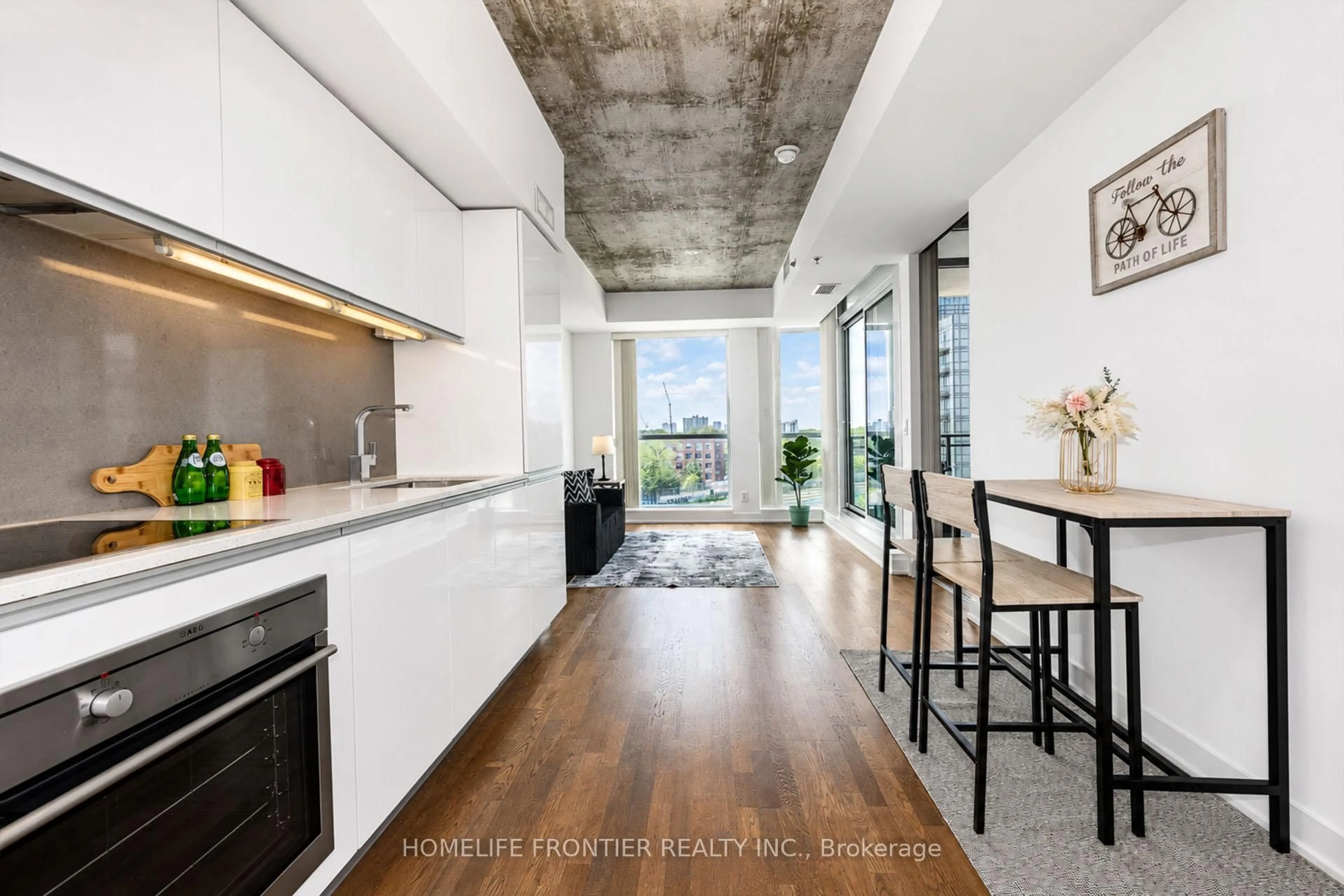 Open concept kitchen, cement floor for 20 Minowan Miikan Lane #717, Toronto Ontario M6J 0E5