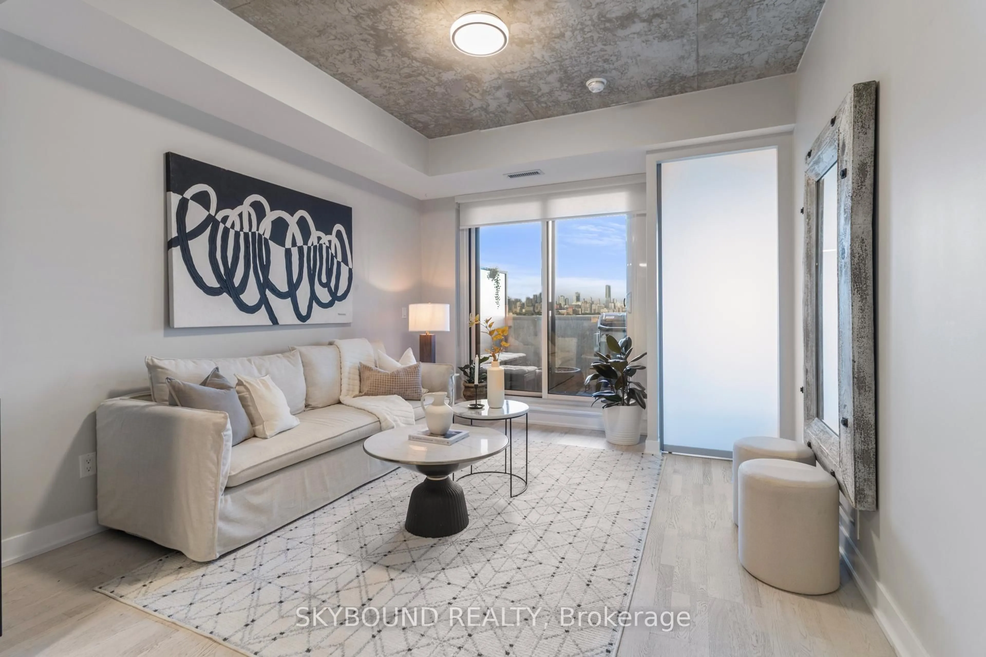 Living room with furniture, cement floor for 20 Minowan Miikan Lane #1023, Toronto Ontario M6J 0E5