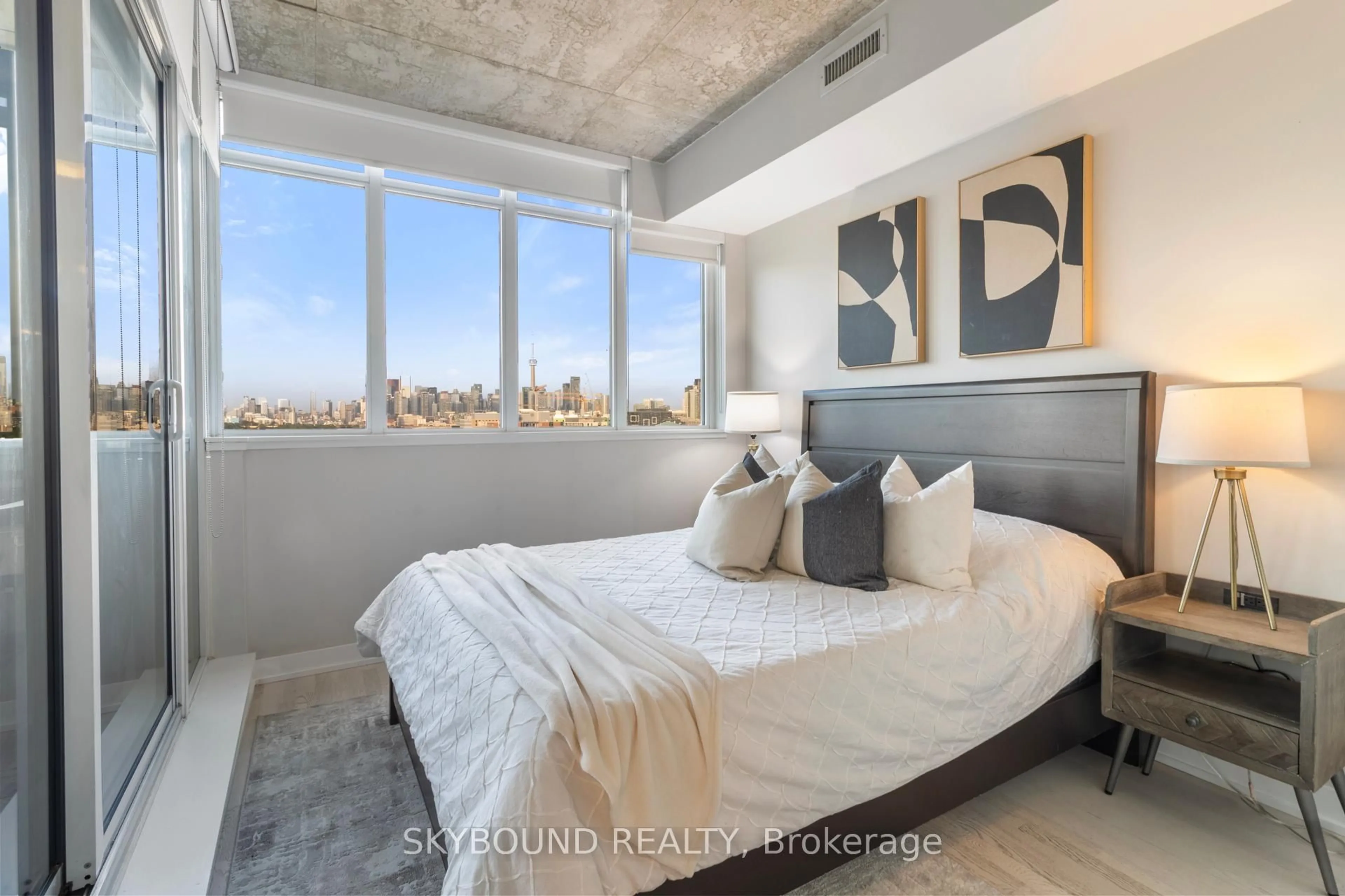 Bedroom with bed, cement floor for 20 Minowan Miikan Lane #1023, Toronto Ontario M6J 0E5