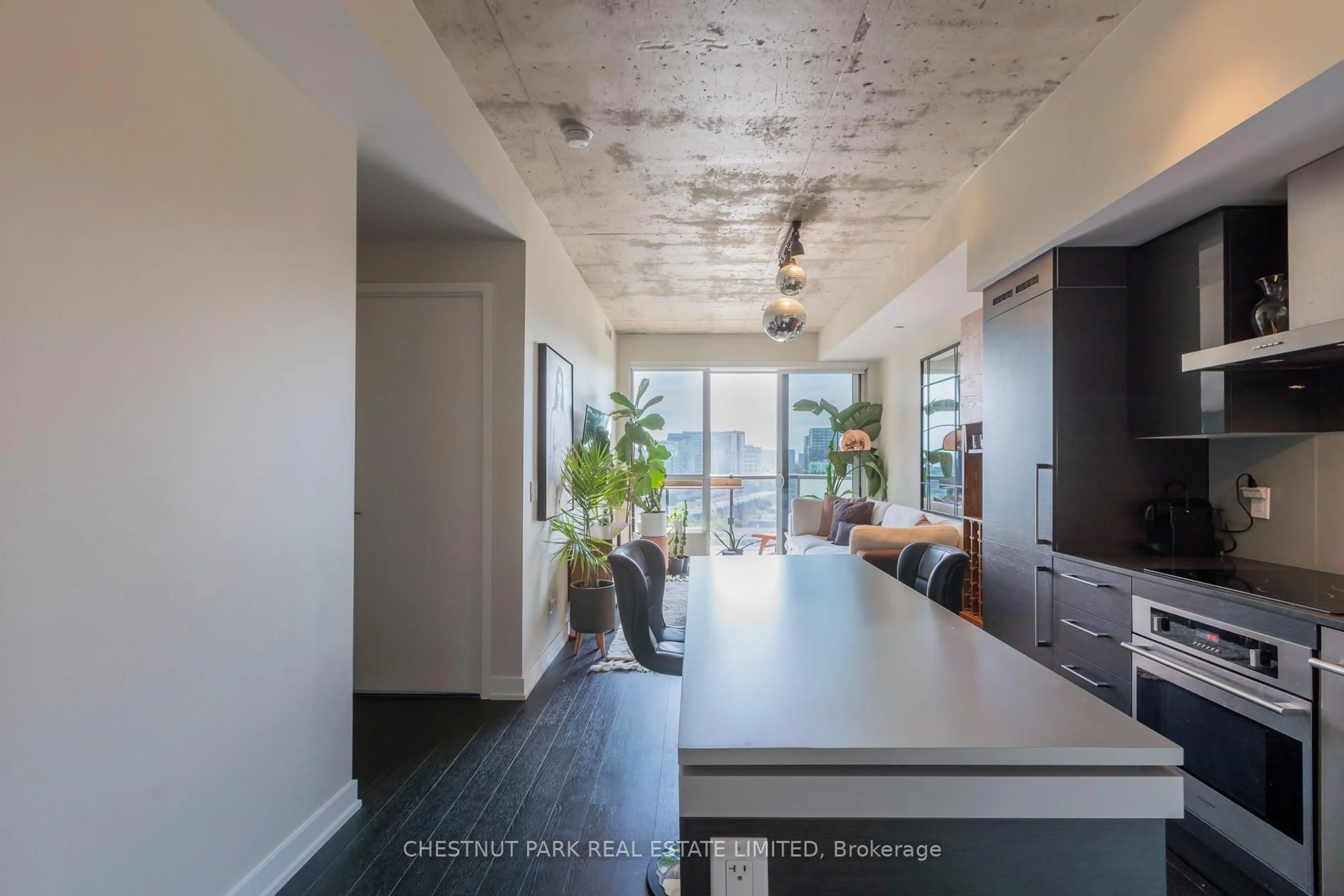Open concept kitchen, cement floor for 1030 King St #1122, Toronto Ontario M6K 0B4