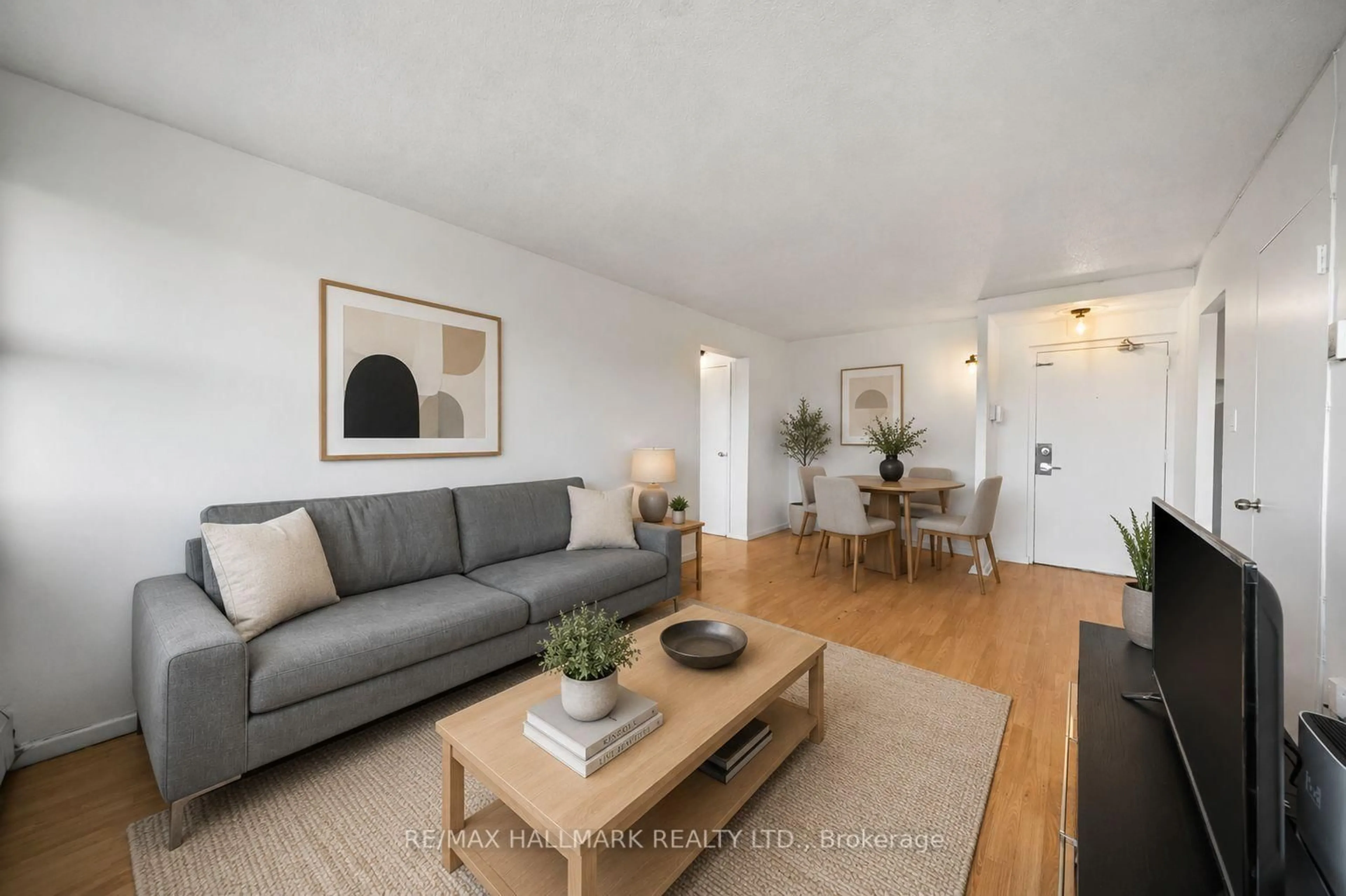 Living room with furniture, wood/laminate floor for 725 Don Mills Rd #304, Toronto Ontario M3C 1S6