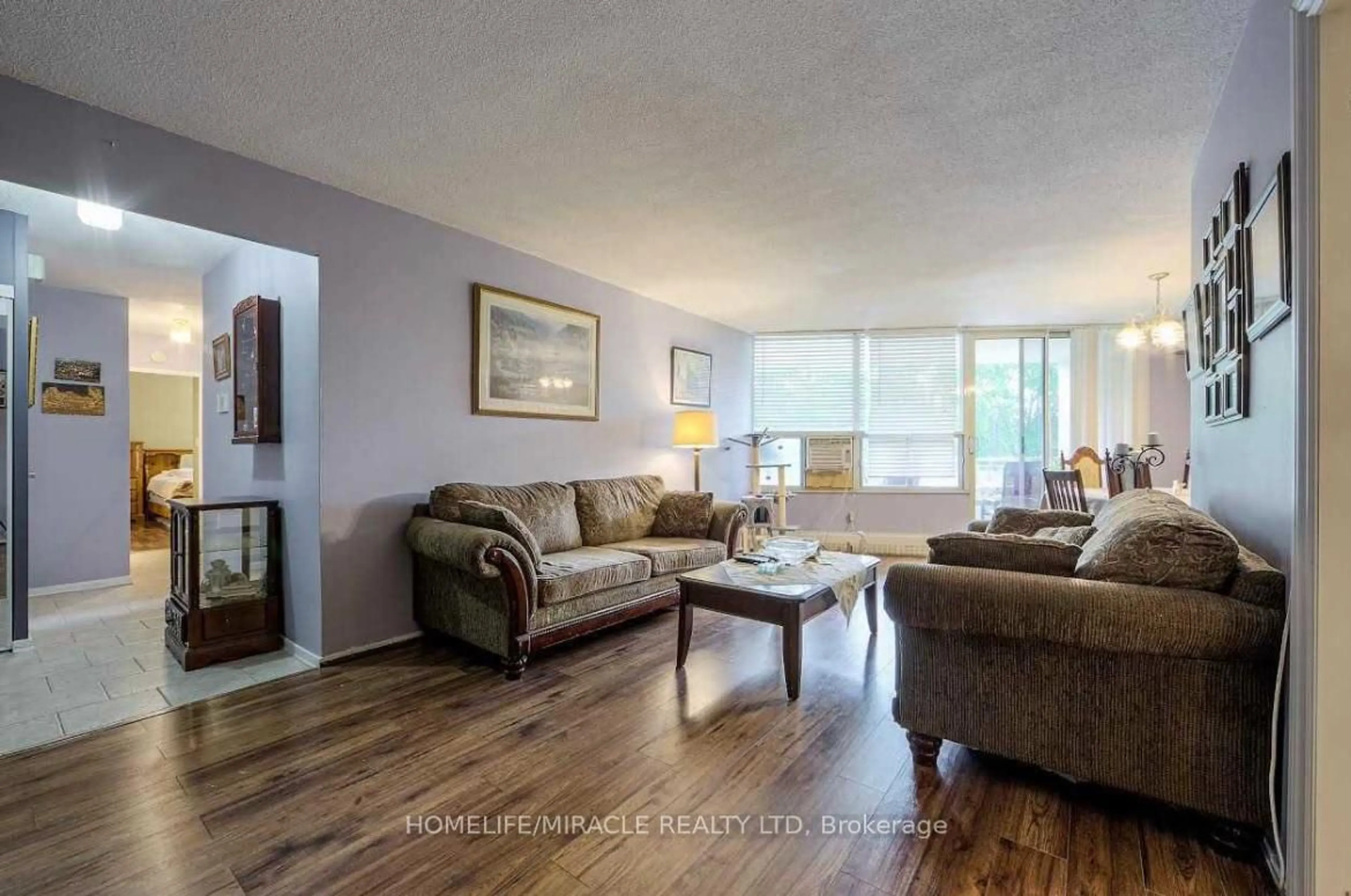 Living room with furniture, wood/laminate floor for 60 Pavane Linkway #216, Toronto Ontario M3C 1A1