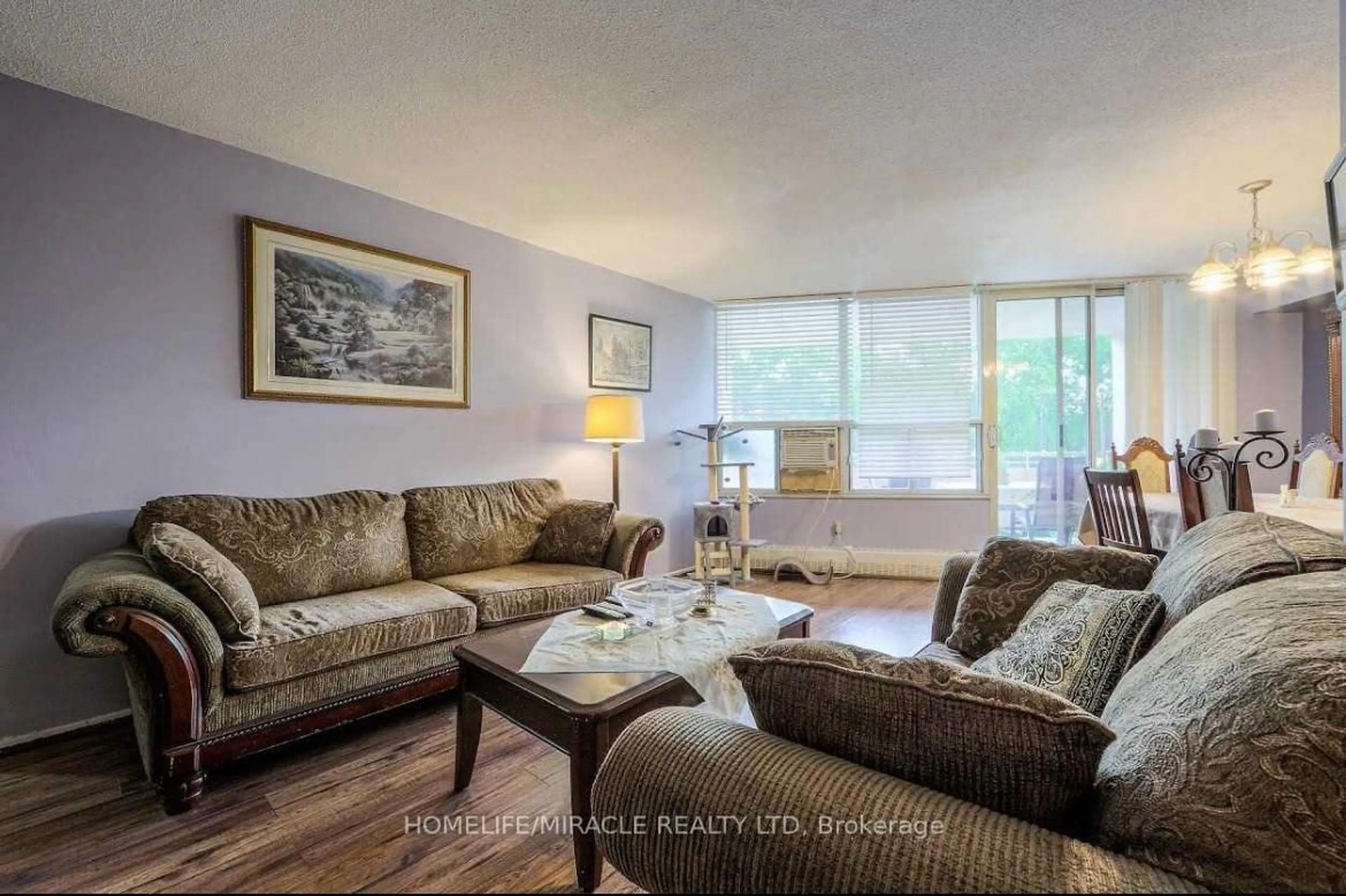 Living room with furniture, wood/laminate floor for 60 Pavane Linkway #216, Toronto Ontario M3C 1A1