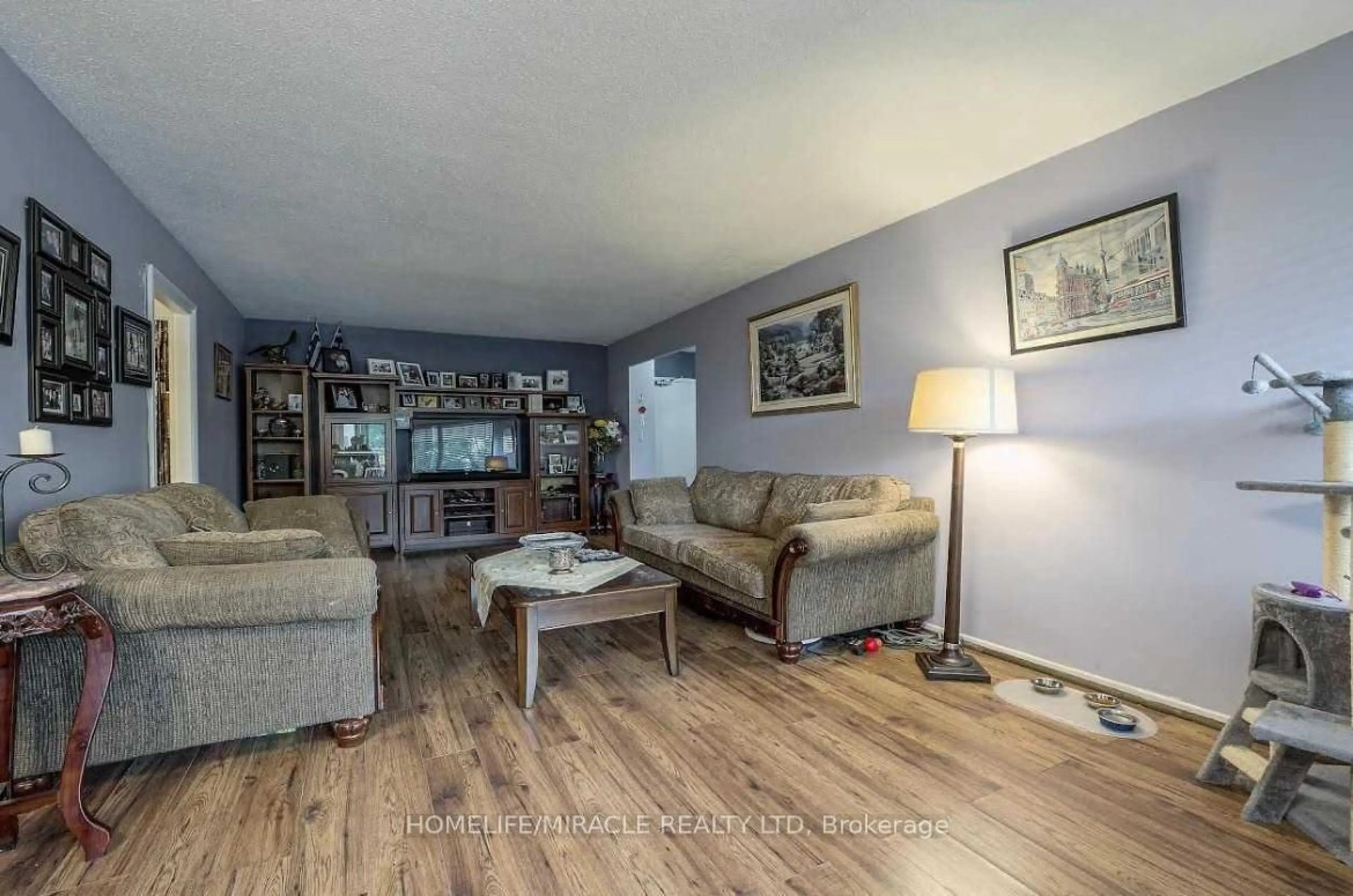Living room with furniture, wood/laminate floor for 60 Pavane Linkway #216, Toronto Ontario M3C 1A1