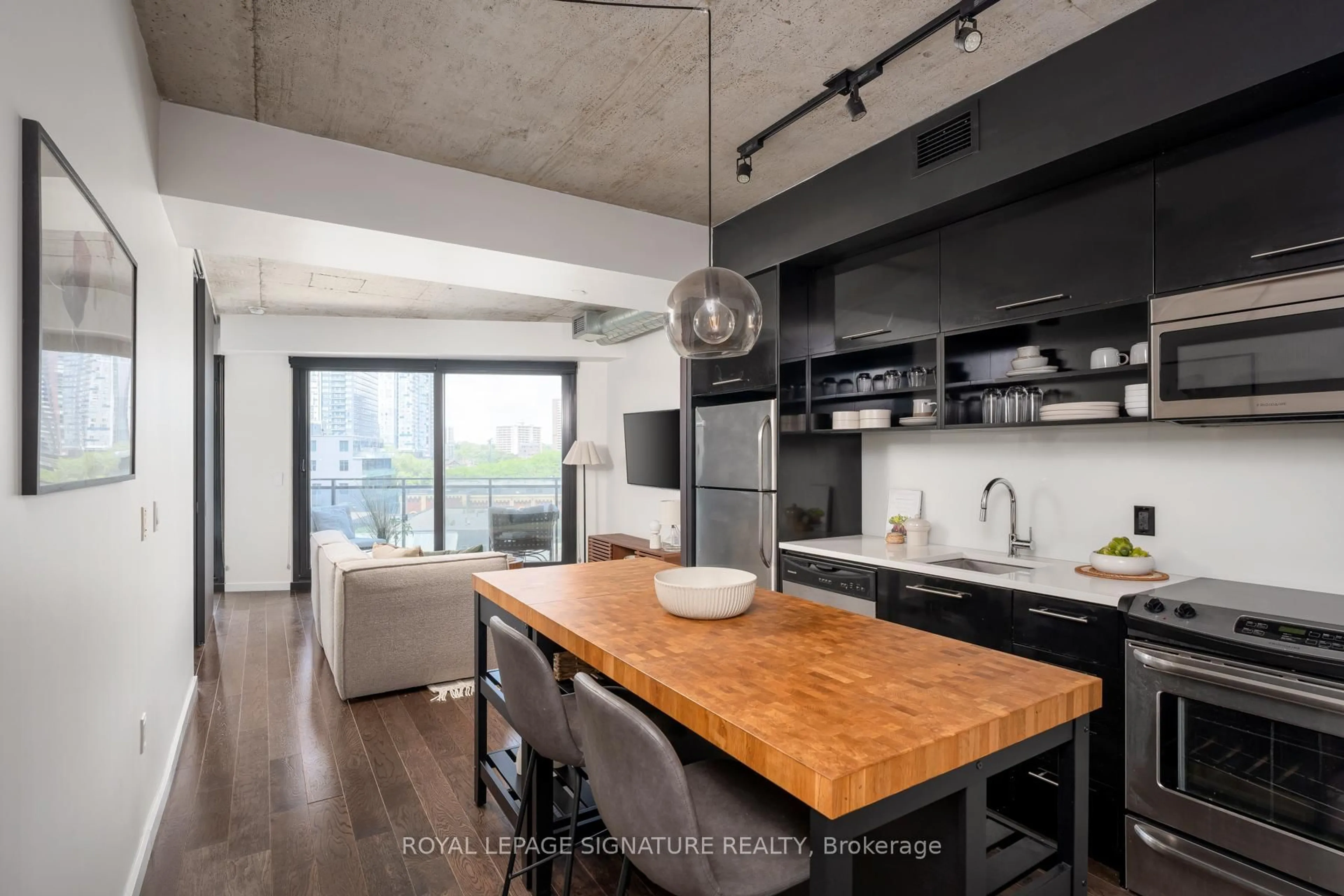 Open concept kitchen, cement floor for 51 Trolley Cres #601, Toronto Ontario M5A 0E9