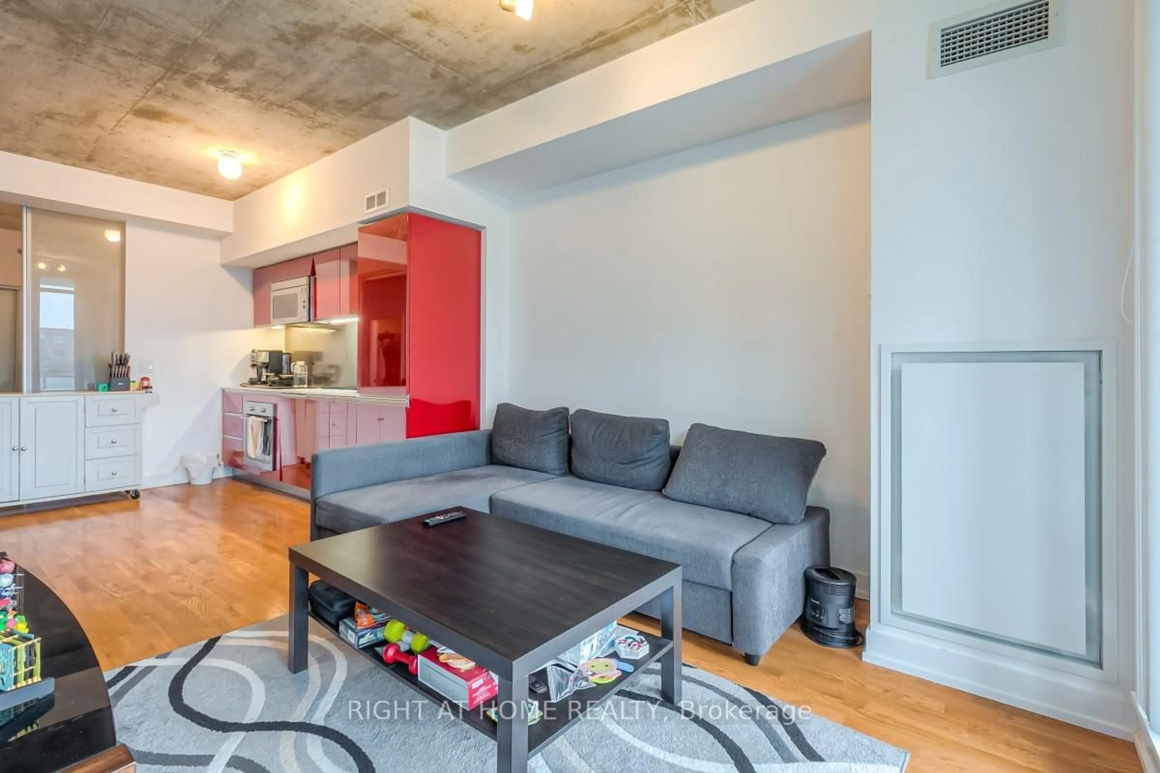 Living room with furniture, cement floor for 20 Minowan Miikan Lane #419, Toronto Ontario M6J 0E5