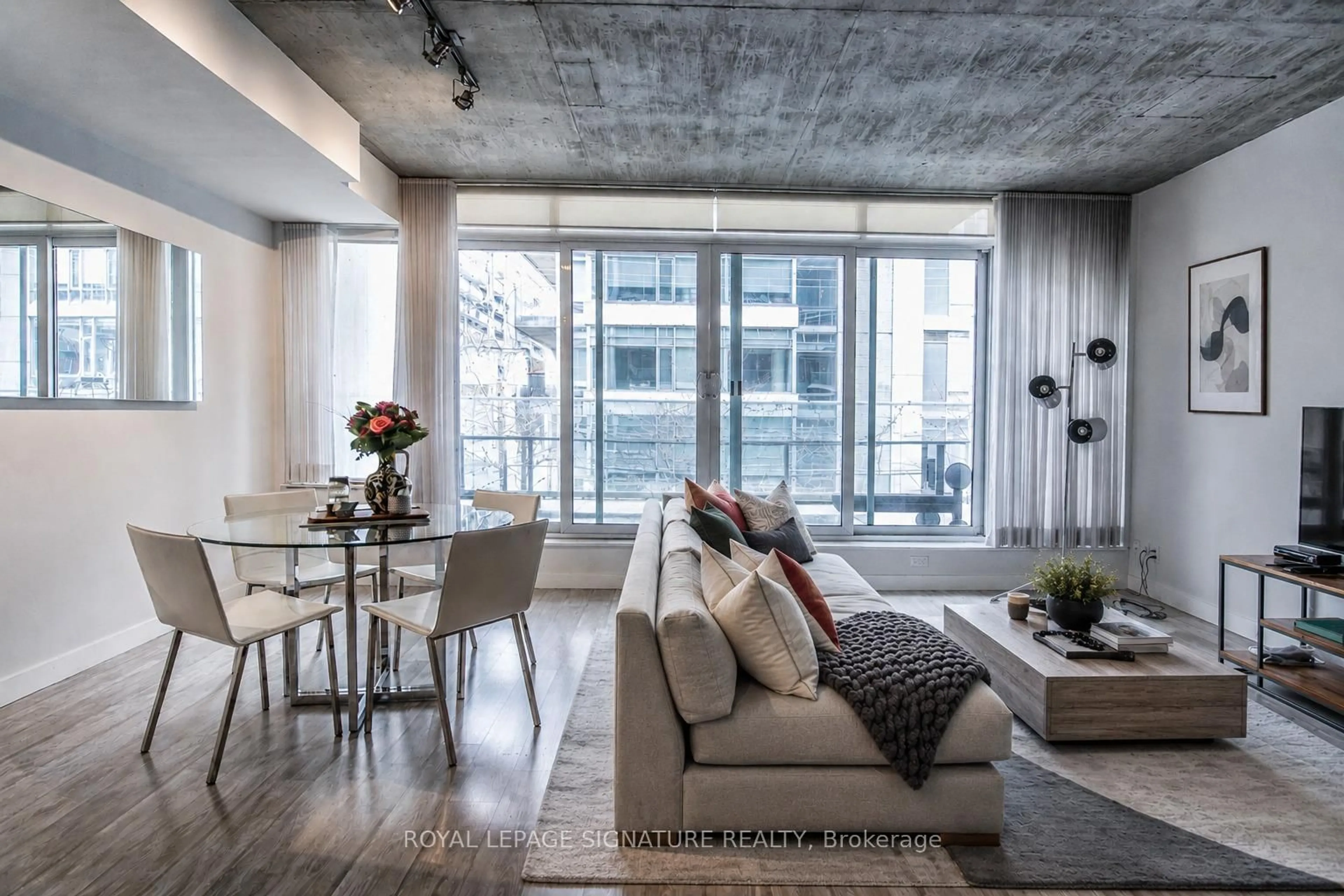 Living room with furniture, cement floor for 75 Portland St #306, Toronto Ontario M5V 2M9