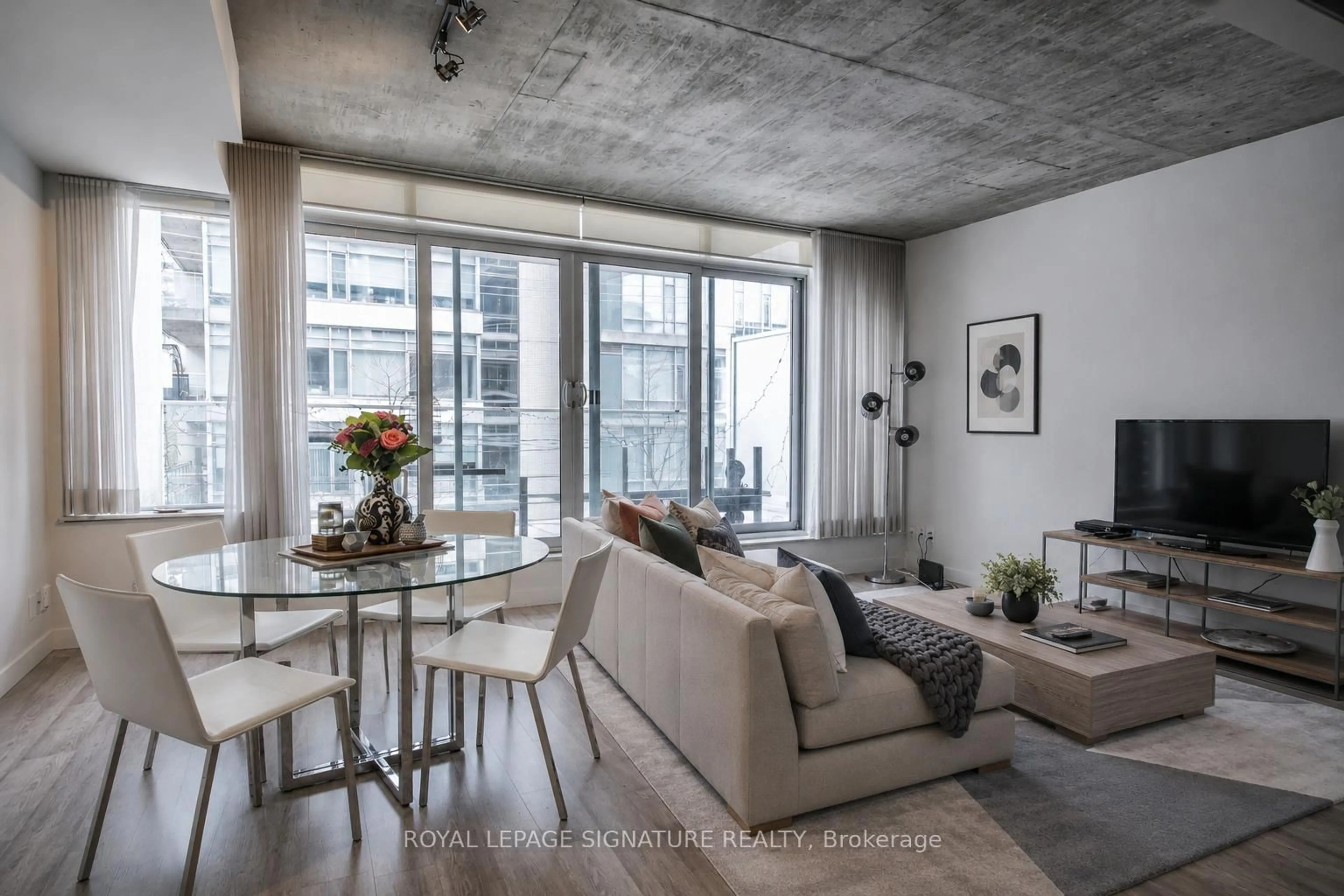 Living room with furniture, cement floor for 75 Portland St #306, Toronto Ontario M5V 2M9