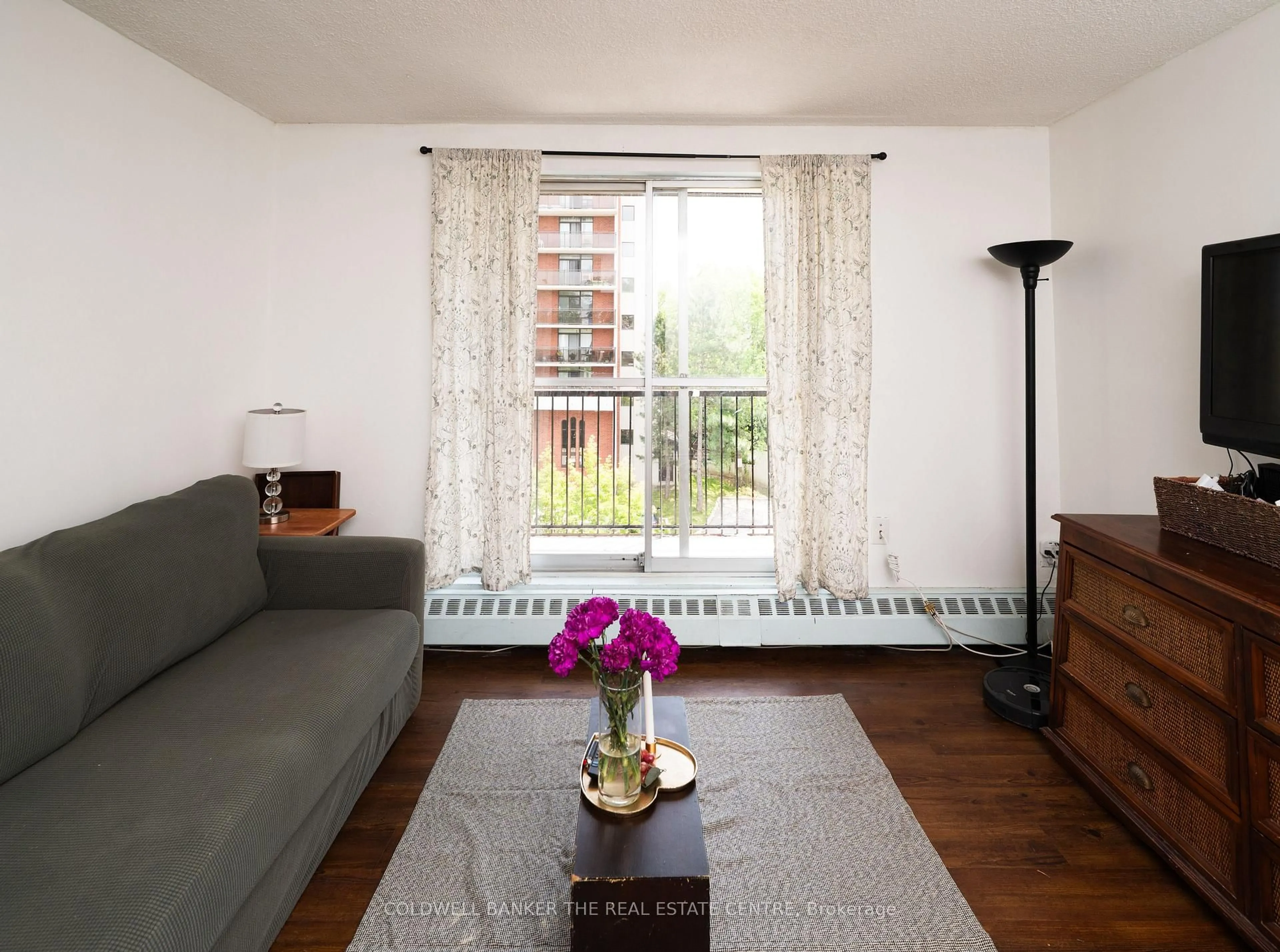 Living room with furniture, wood/laminate floor for 1690 Victoria Park Ave #404, Toronto Ontario M1R 1R1