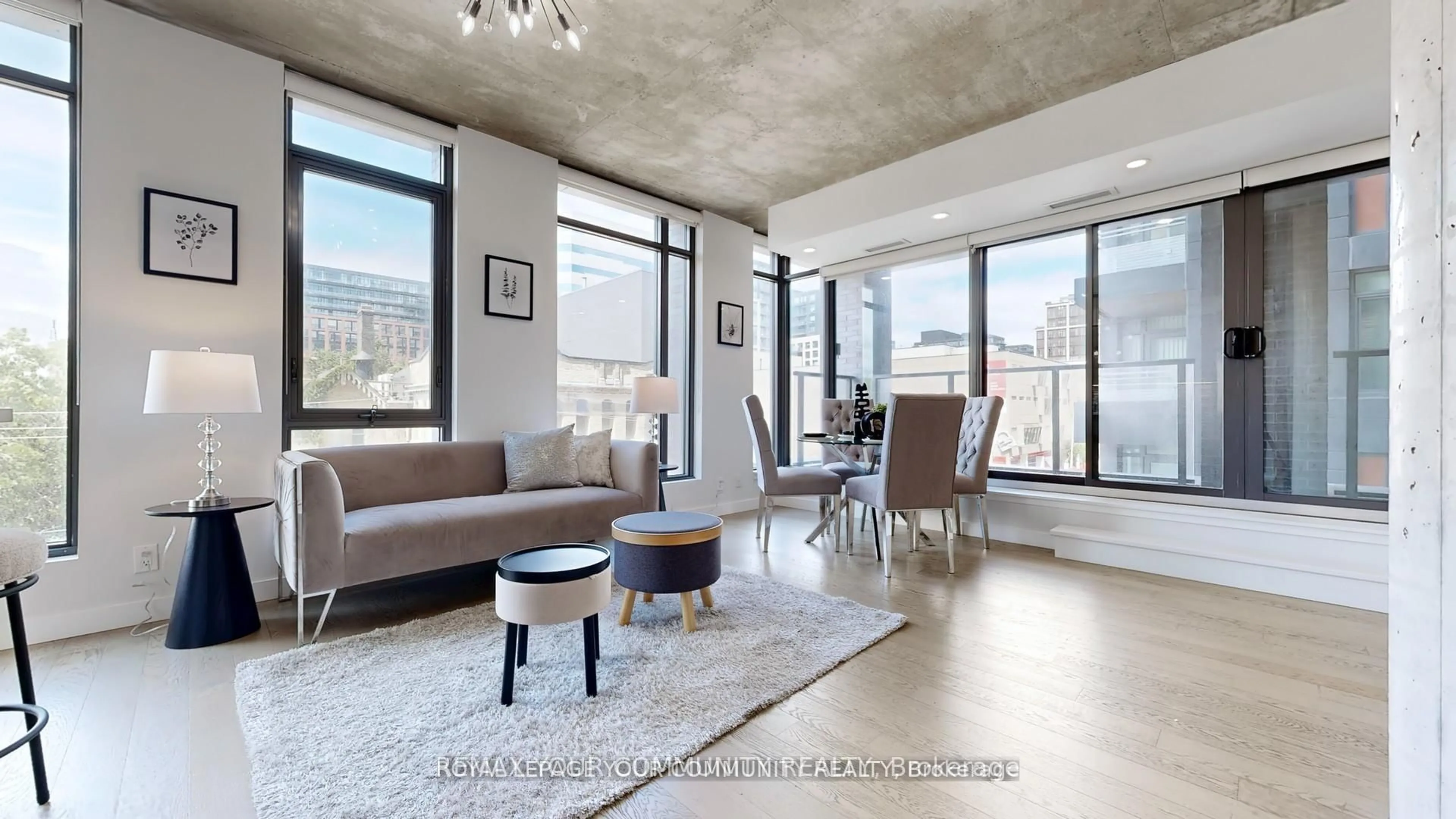 Living room with furniture, cement floor for 111 Bathurst St #314, Toronto Ontario M5V 0M9