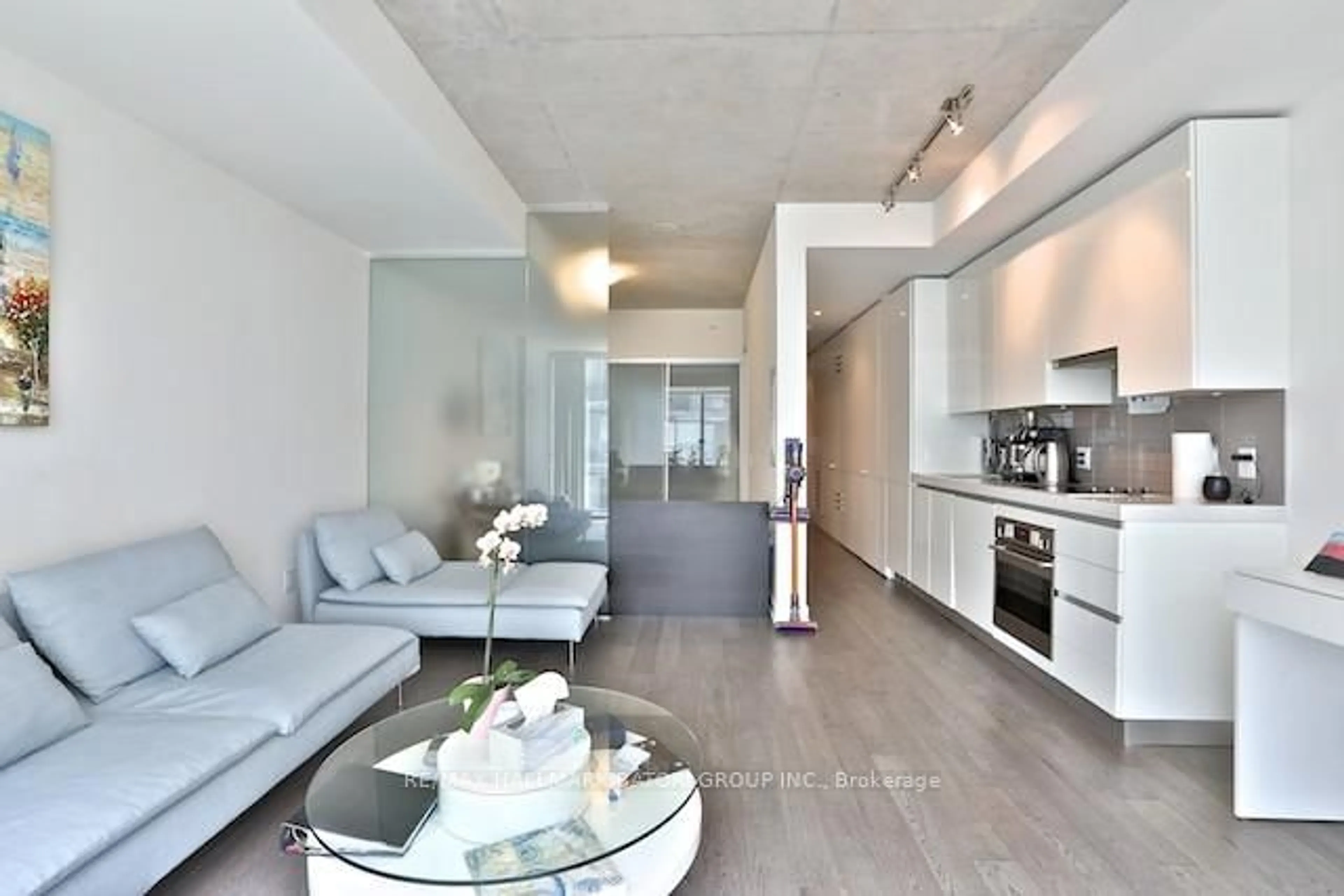 Living room with furniture, cement floor for 38 Stewart St #302, Toronto Ontario M5V 1H6
