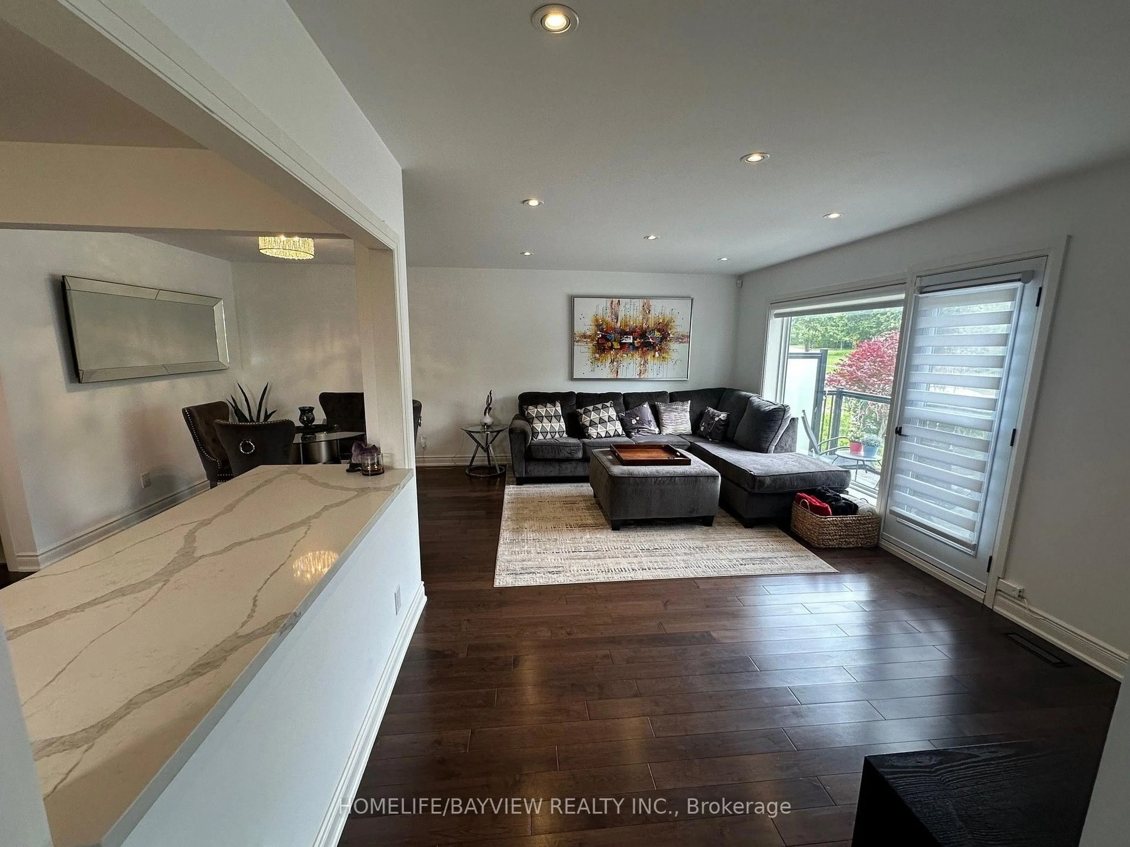 Living room with furniture, wood/laminate floor for 68 Knighton Dr, Toronto Ontario M4A 1W2