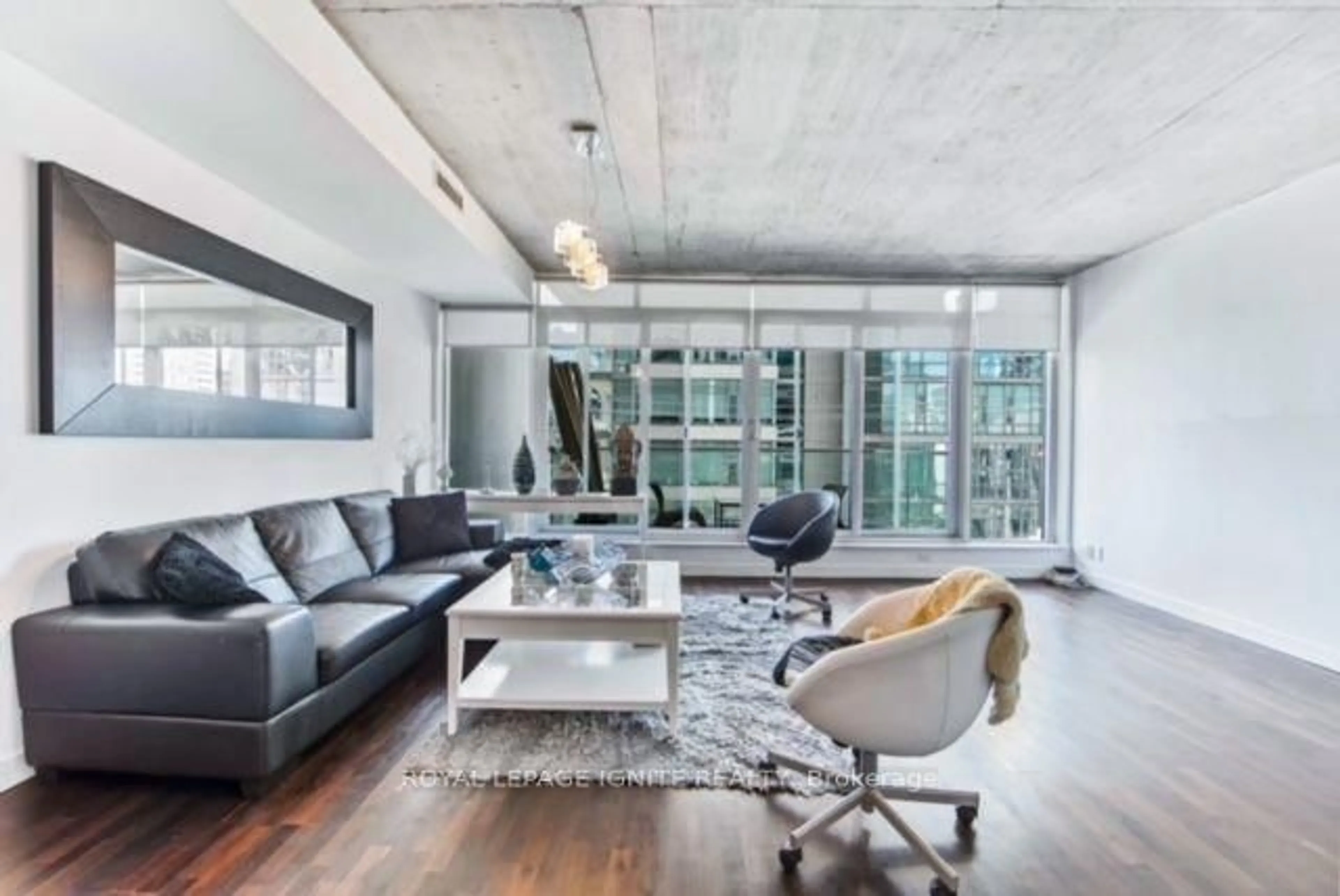 Living room with furniture, cement floor for 75 Portland St #406, Toronto Ontario M5V 2M9