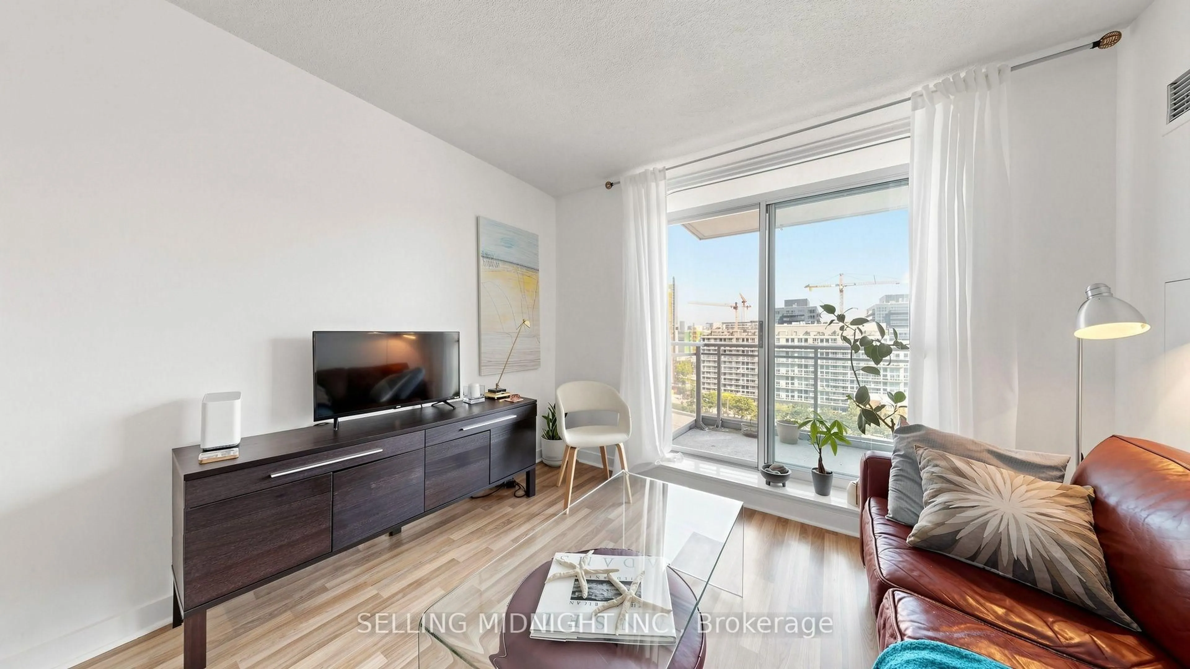 Living room with furniture, wood/laminate floor for 50 Lynn Williams St #1010, Toronto Ontario M6K 3R9