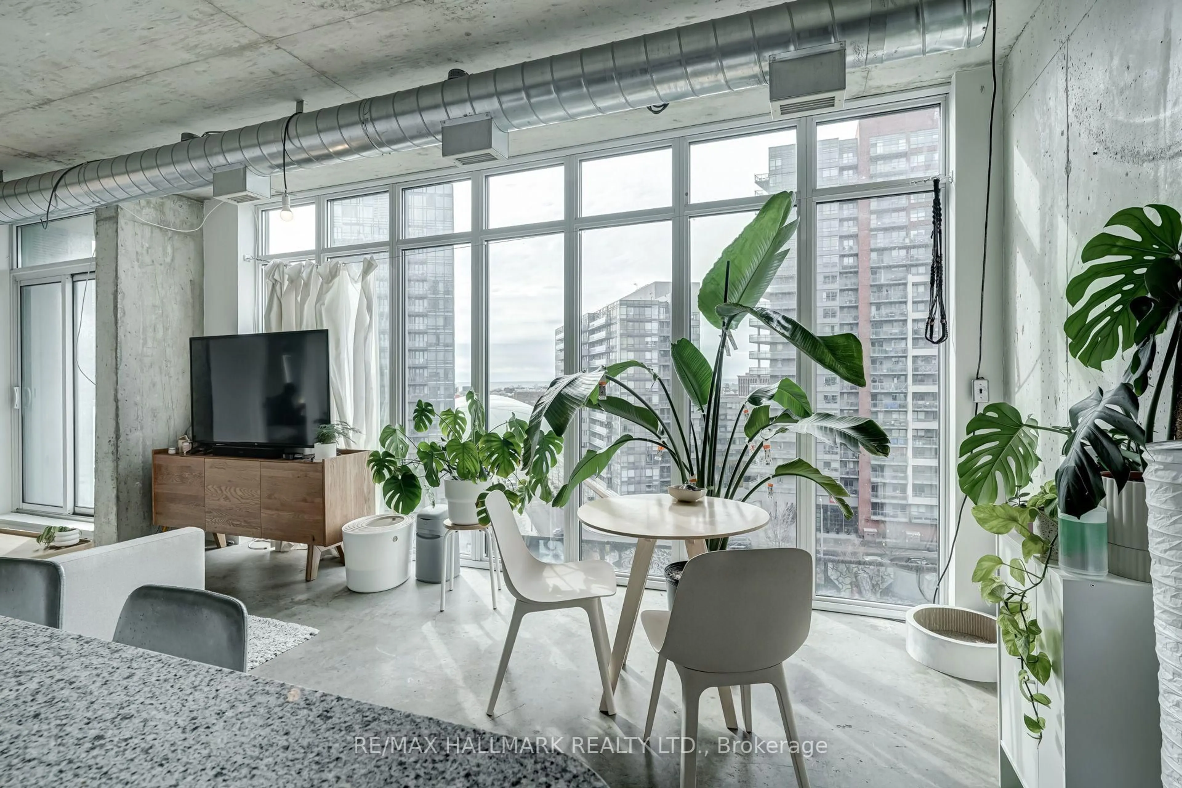 Living room with furniture, cement floor for 150 Sudbury St #910, Toronto Ontario M6J 3S8