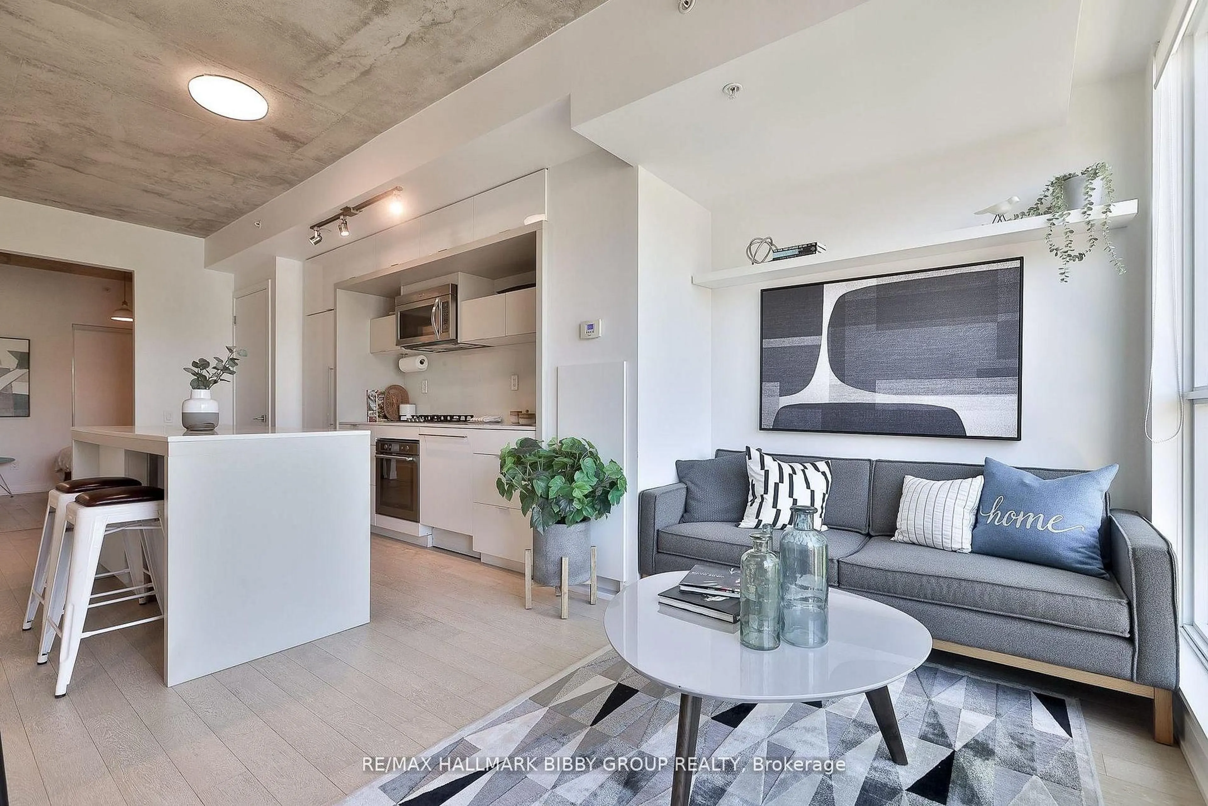Living room with furniture, cement floor for 130 Rusholme Rd #309, Toronto Ontario M6H 1A7