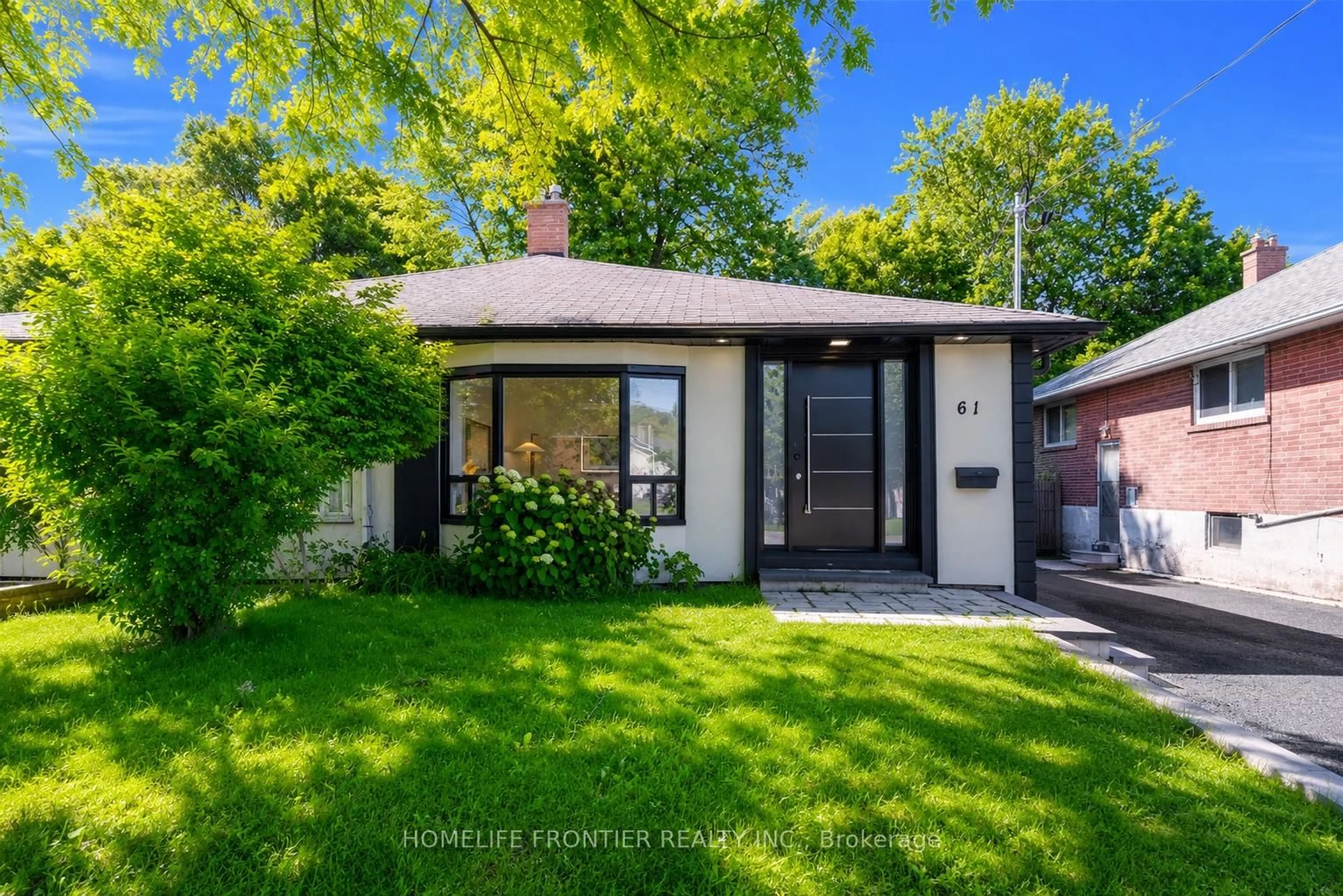 Home with brick exterior material, street for 61 Sundial Cres, Toronto Ontario M4A 2J7