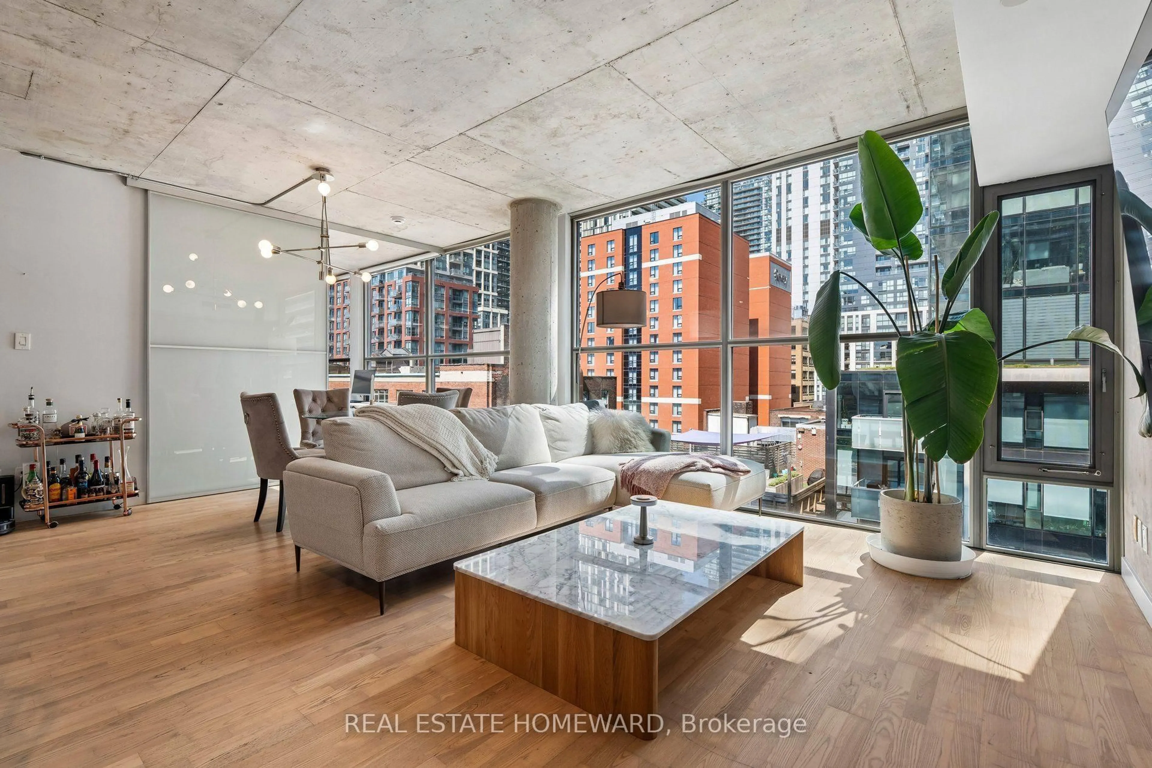 Living room with furniture, cement floor for 25 Oxley St #807, Toronto Ontario M5V 2J5