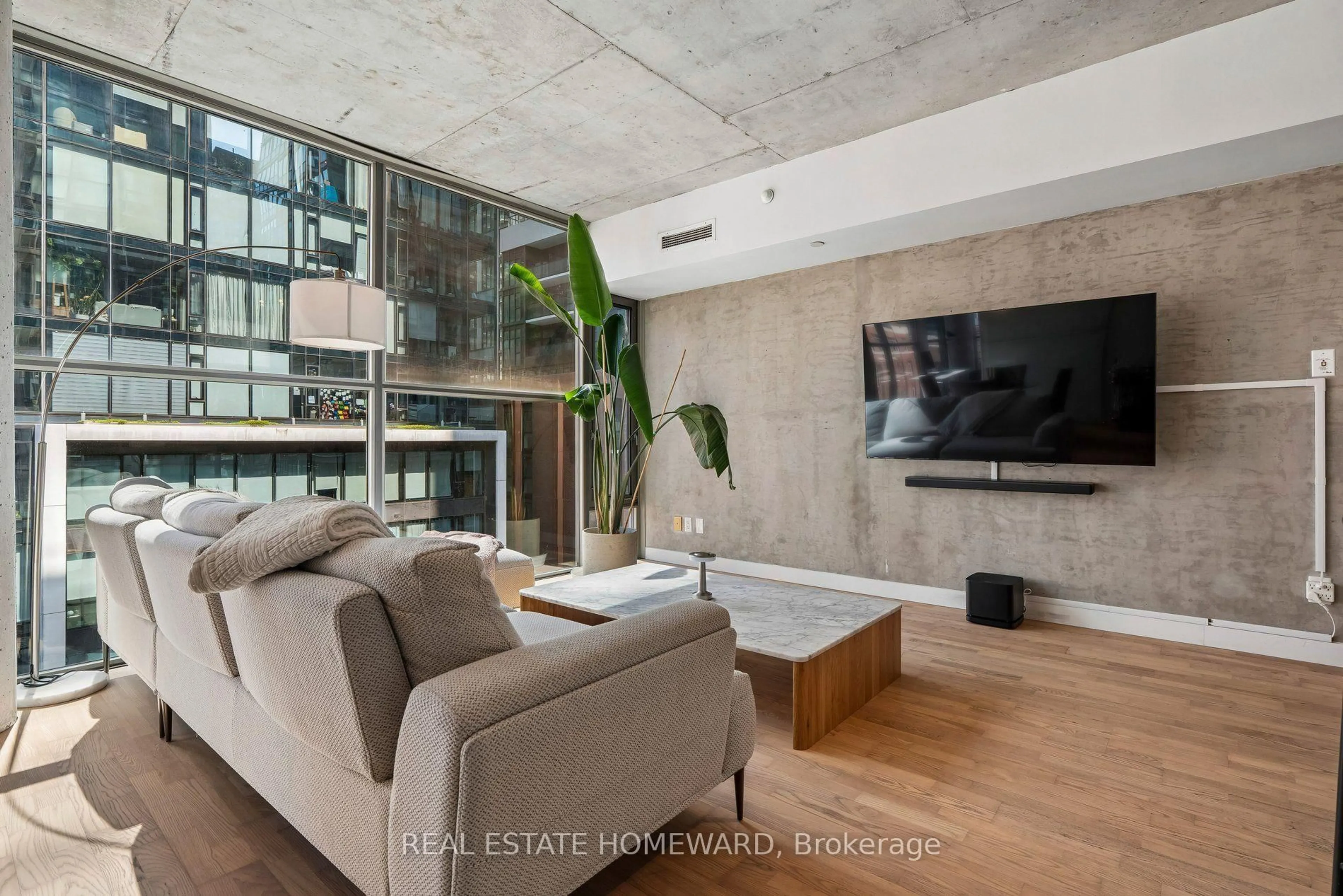 Living room with furniture, cement floor for 25 Oxley St #807, Toronto Ontario M5V 2J5