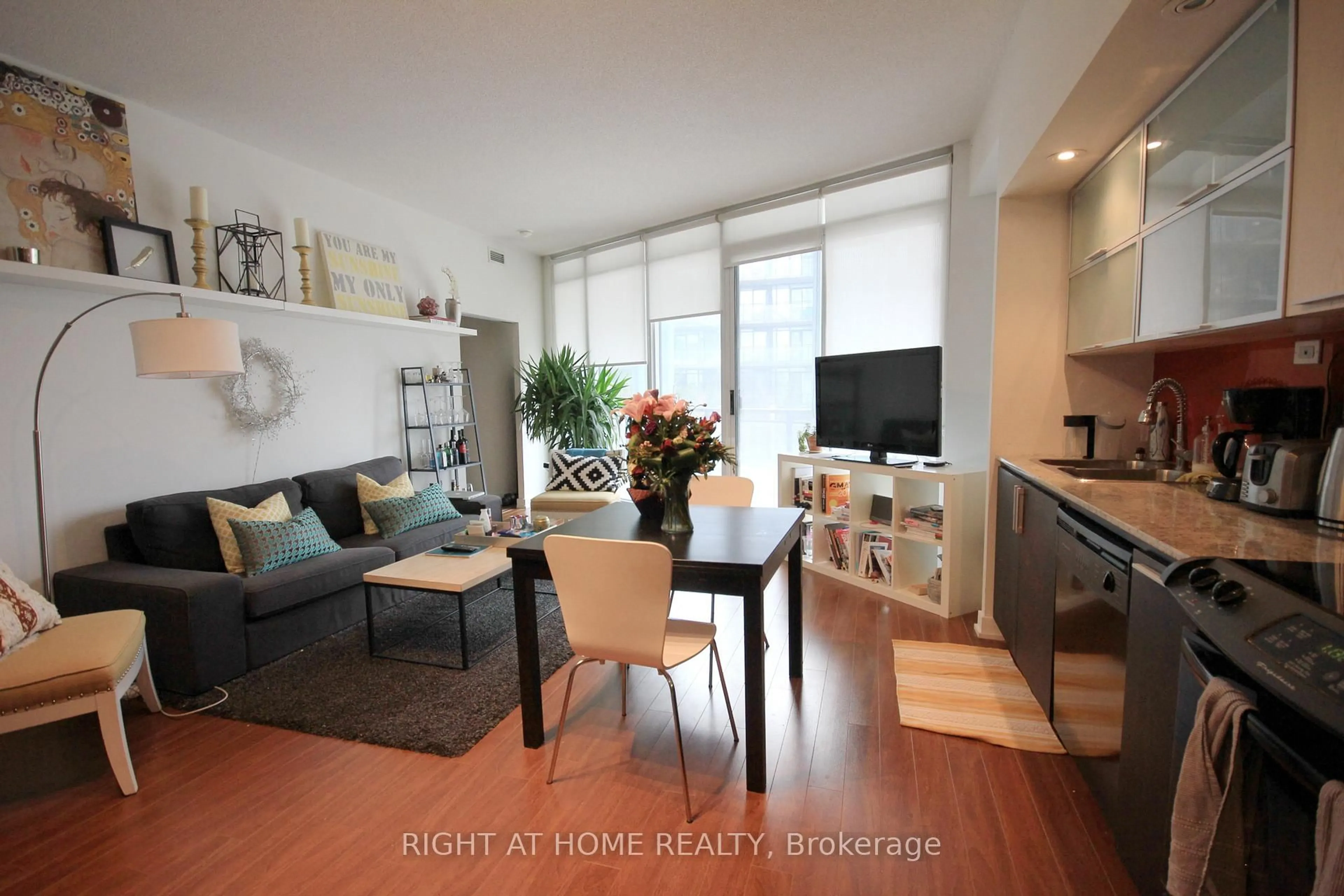 Living room with furniture, wood/laminate floor for 25 Capreol Crt #310, Toronto Ontario M5V 3Z7