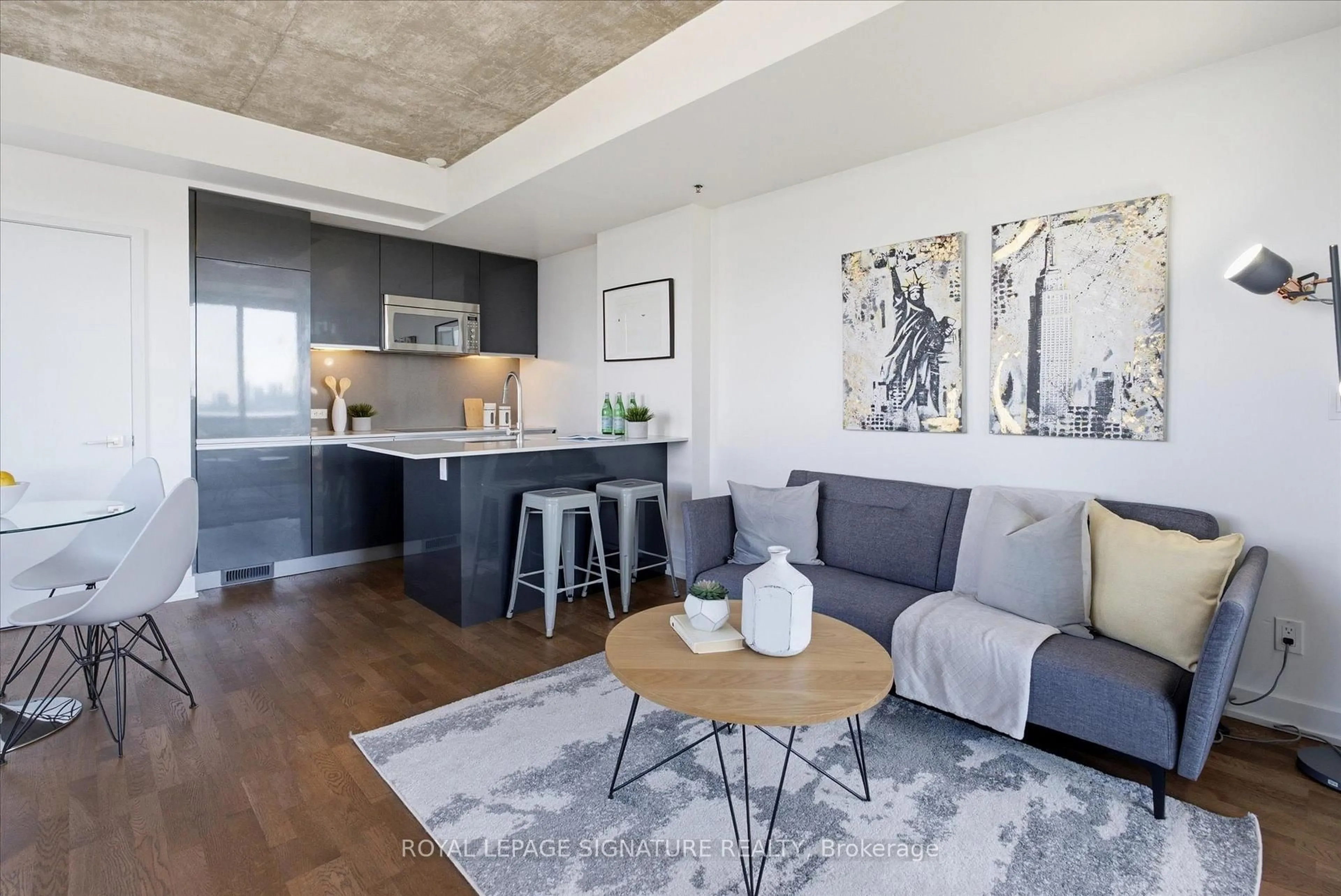 Living room with furniture, cement floor for 20 Minowan Miikan Lane #921, Toronto Ontario M6J 0E5