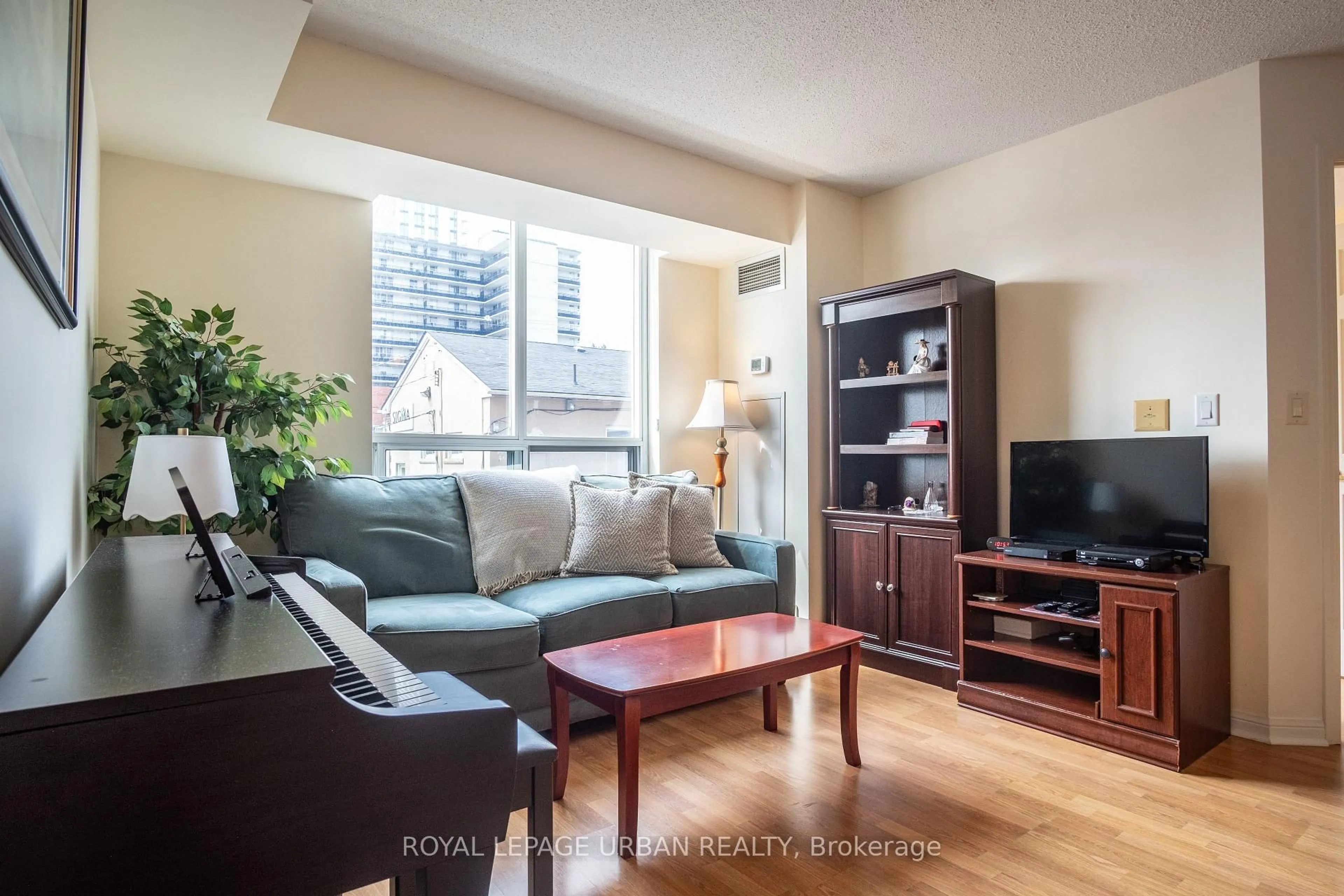 Living room with furniture, wood/laminate floor for 5940 Yonge St #201, Toronto Ontario M2M 4M6
