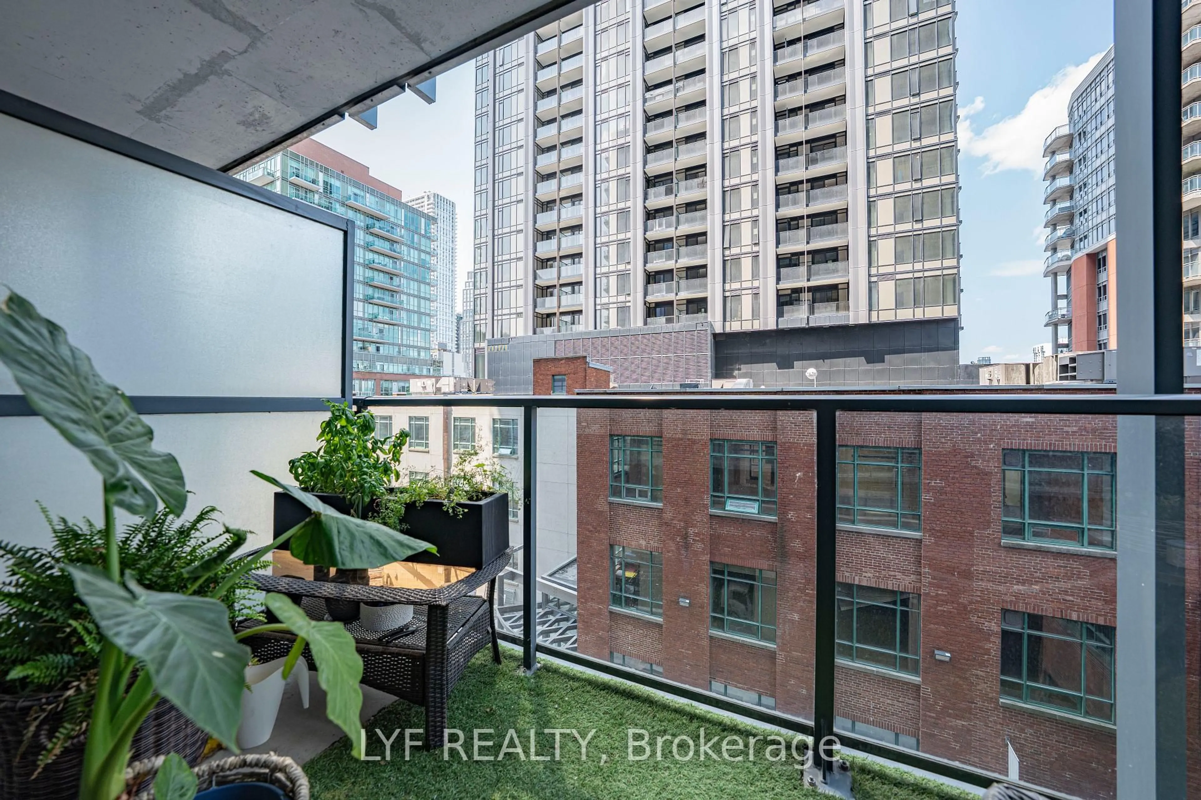 Balcony in the apartment, city buildings view from balcony for 105 George St #402, Toronto Ontario M5A 0L4