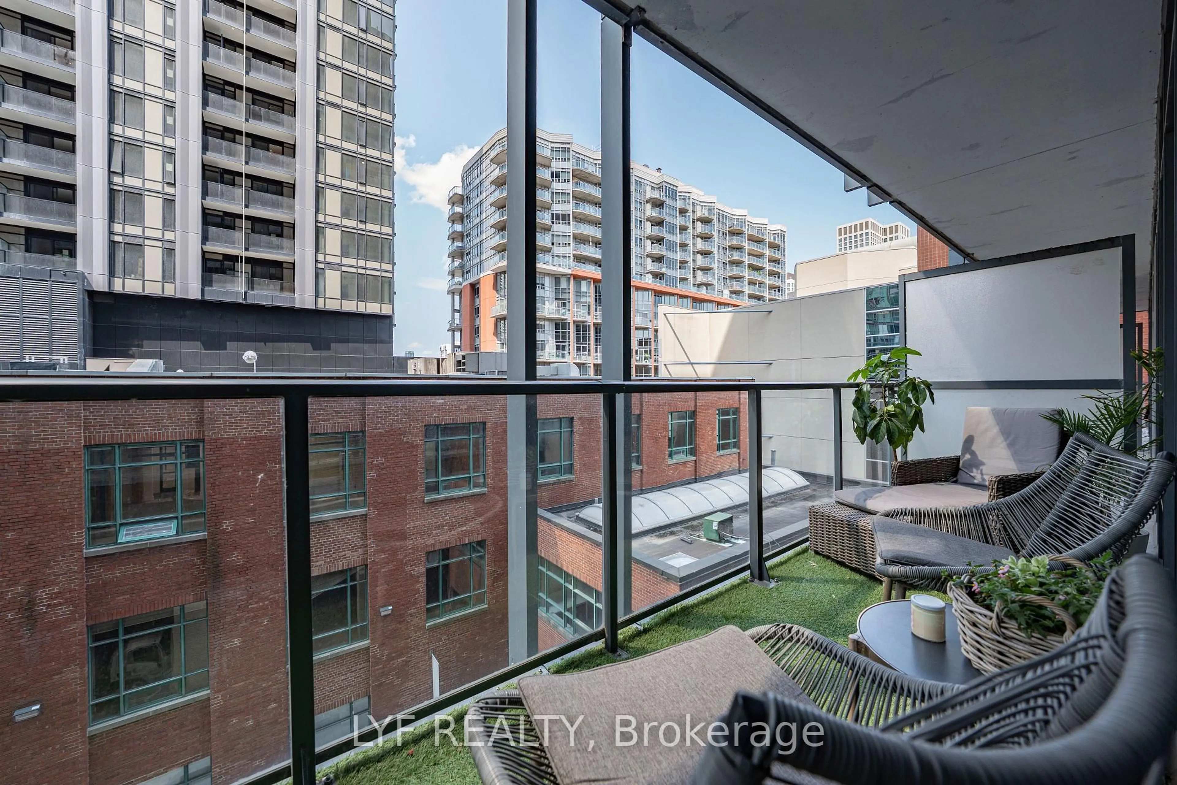 Balcony in the apartment, city buildings view from balcony for 105 George St #402, Toronto Ontario M5A 0L4