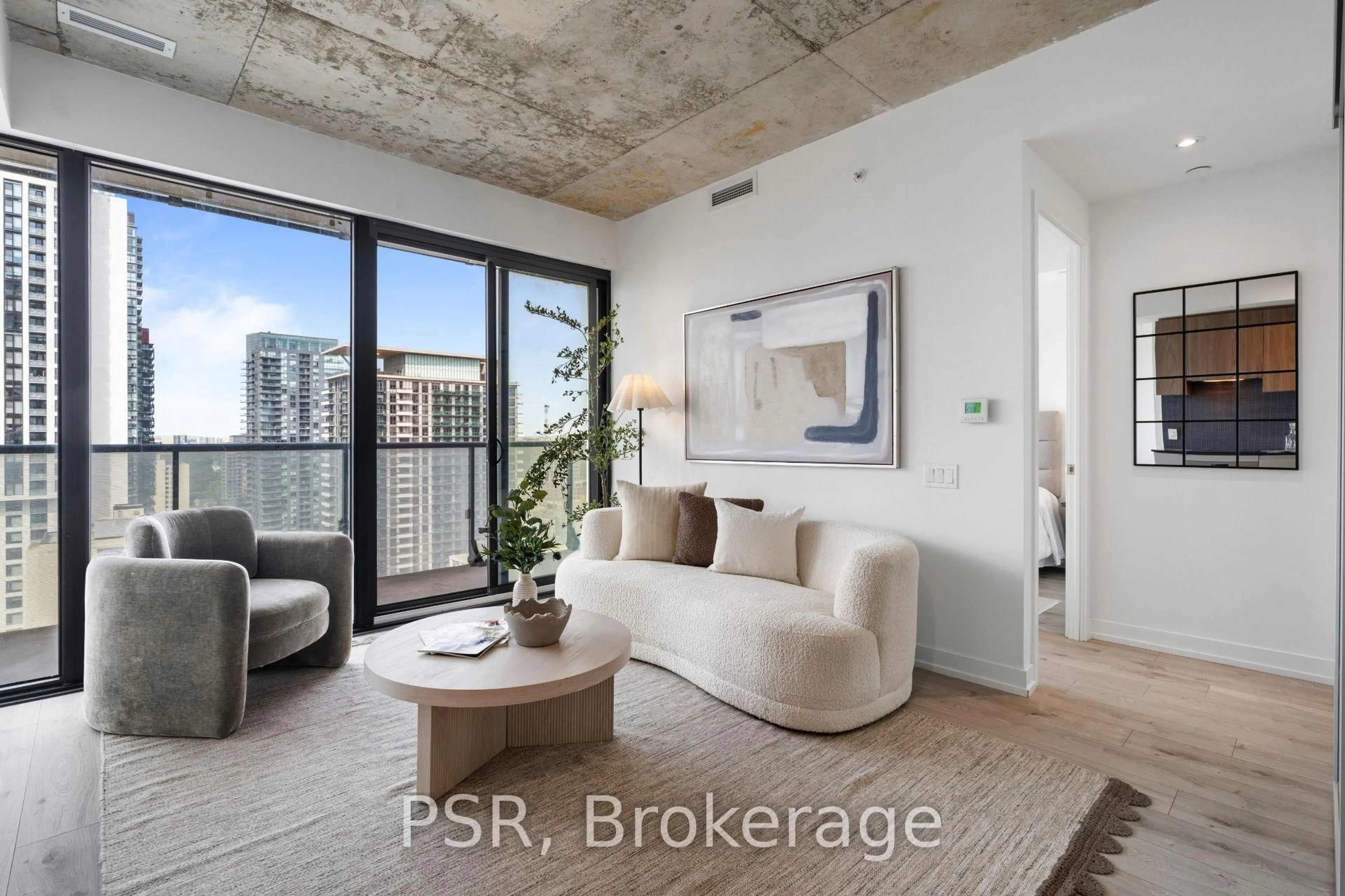 Living room with furniture, cement floor for 161 Roehampton Ave #2601, Toronto Ontario M4P 0C8