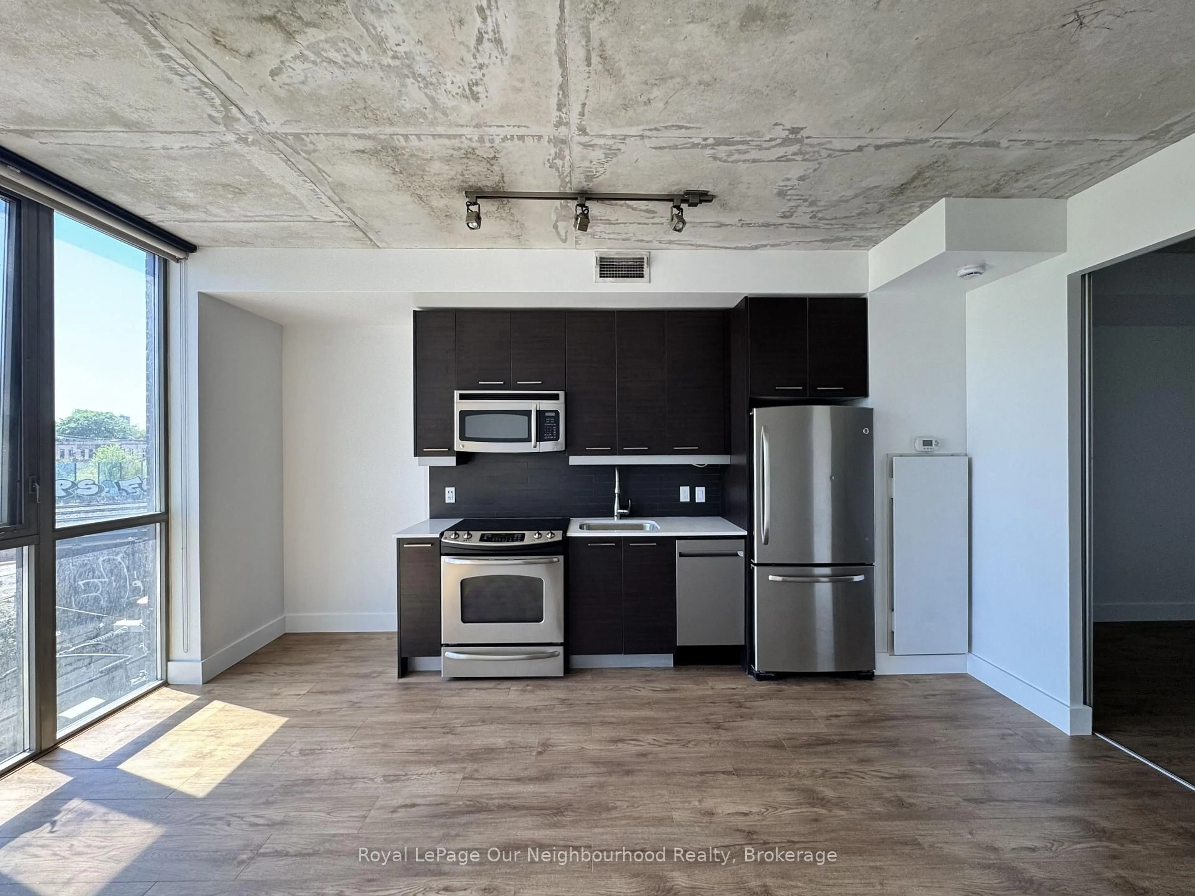 Open concept kitchen, cement floor for 2 Gladstone Ave #308, Toronto Ontario M6J 0B2