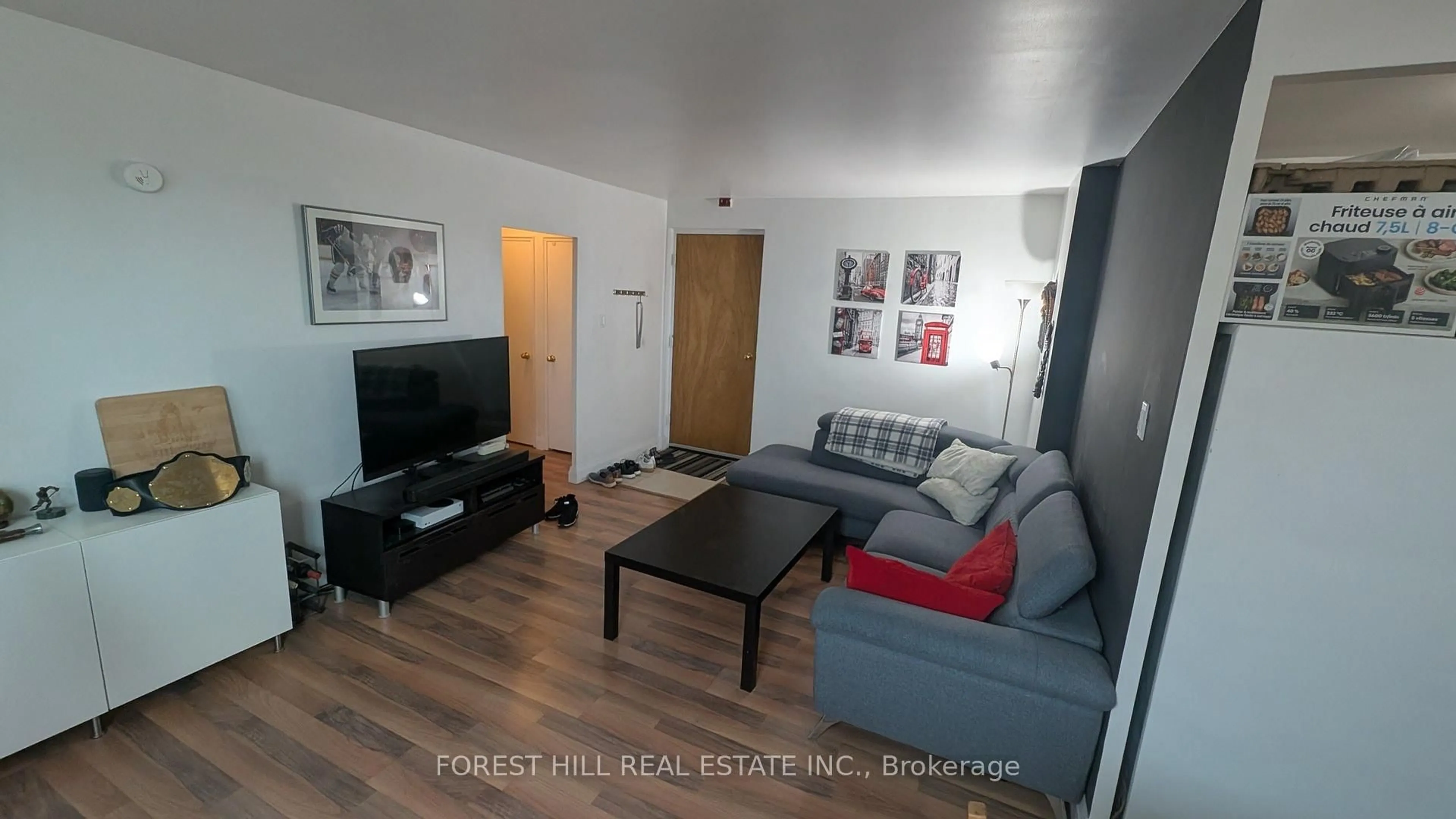 Living room with furniture, wood/laminate floor for 55 Neptune Dr #305, Toronto Ontario M6A 1X2