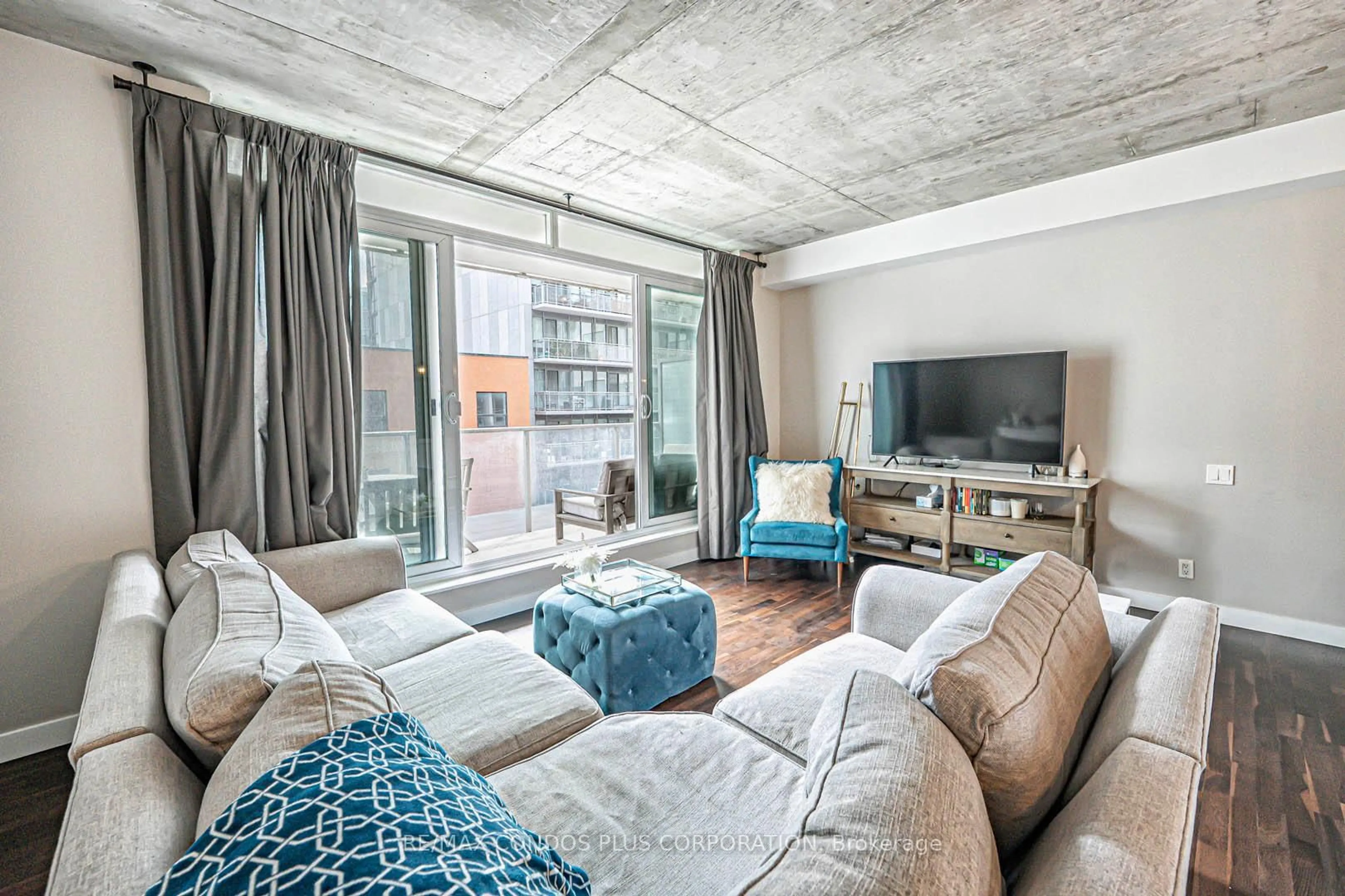 Living room with furniture, cement floor for 75 Portland St #424, Toronto Ontario M5V 2M9