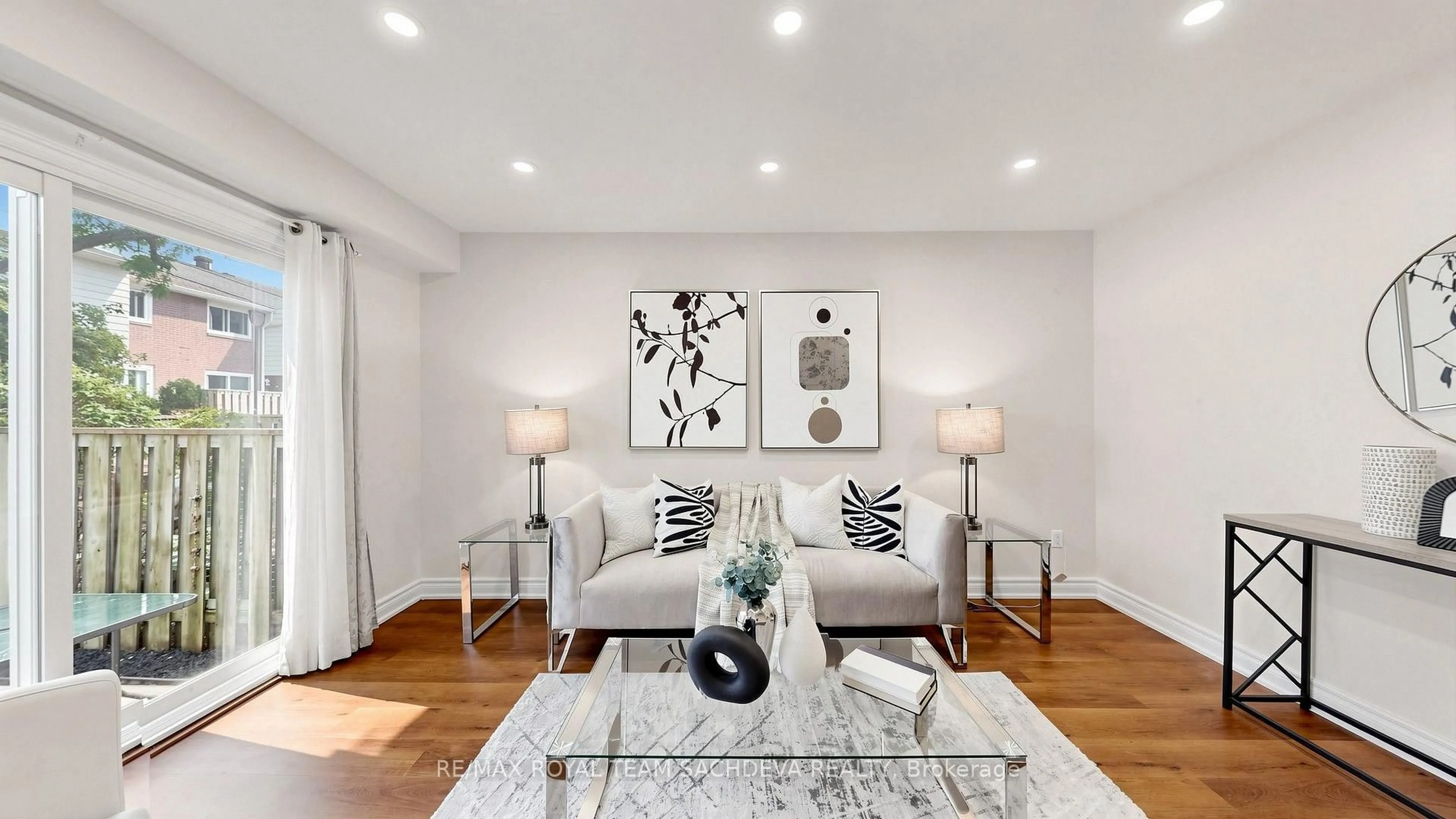 Living room with furniture, wood/laminate floor for 67 Rock Fernway, Toronto Ontario M2J 4N3