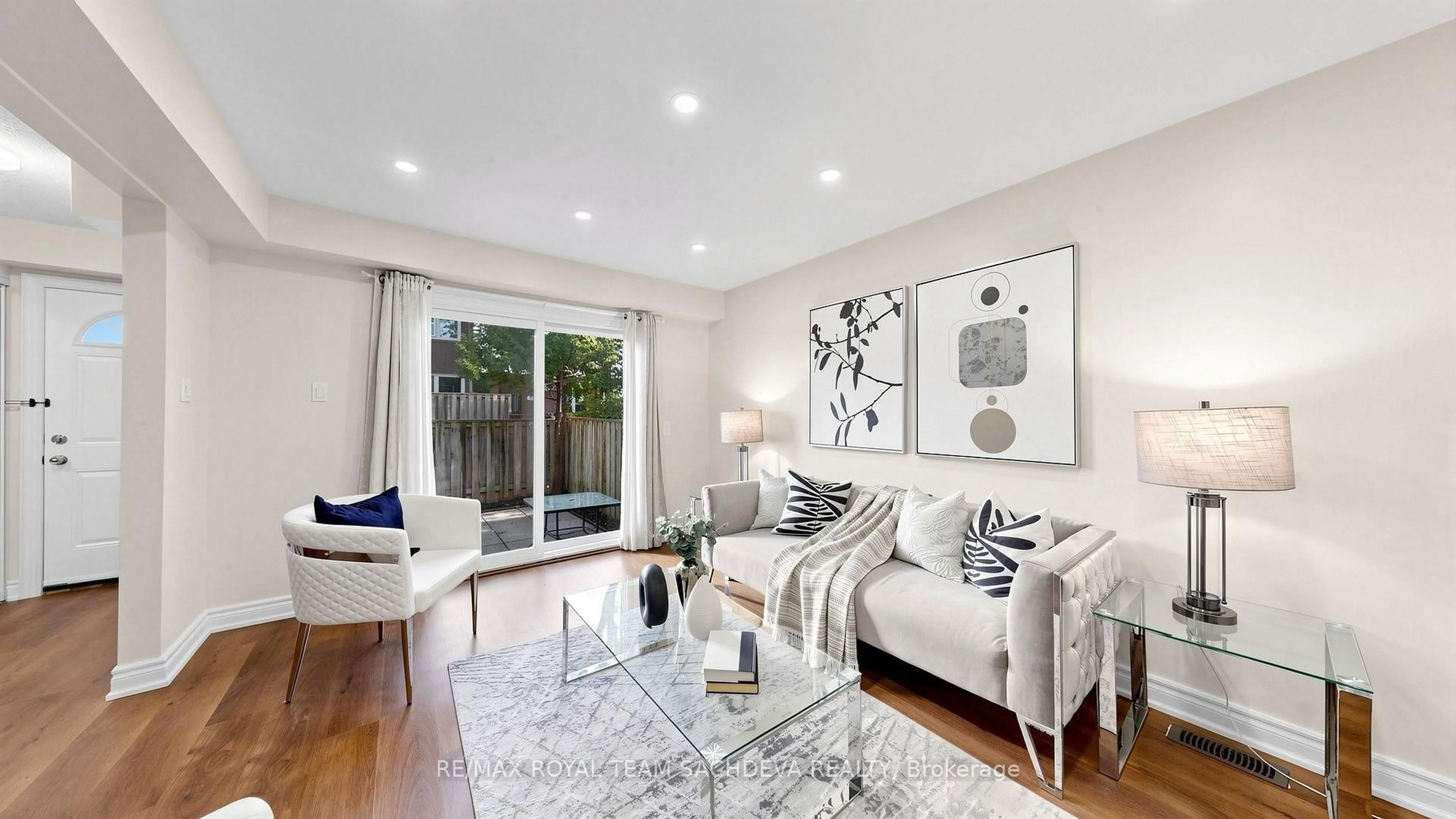 Living room with furniture, wood/laminate floor for 67 Rock Fernway, Toronto Ontario M2J 4N3
