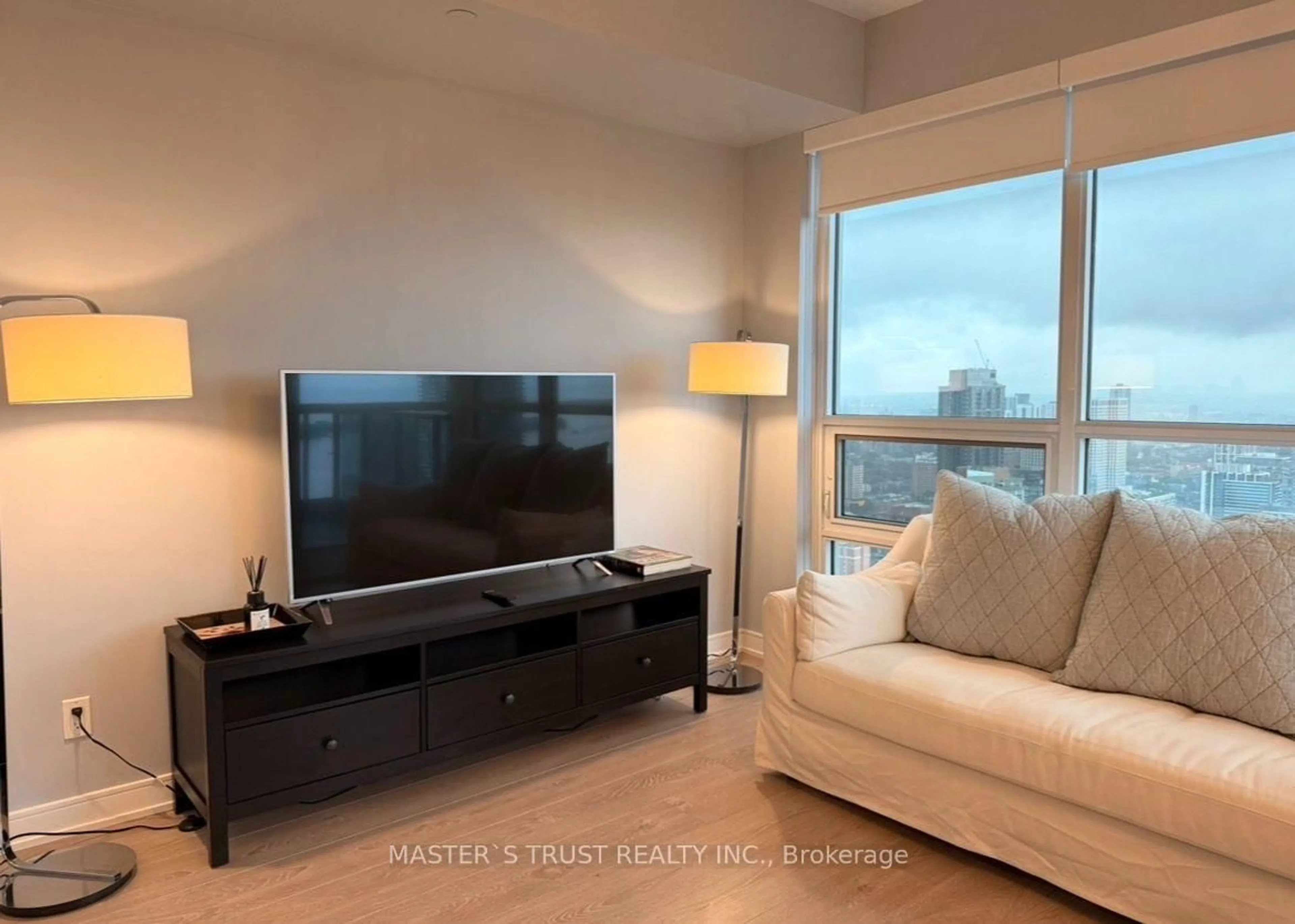 Living room with furniture, wood/laminate floor for 88 Scott St #4106, Toronto Ontario M5E 0A9