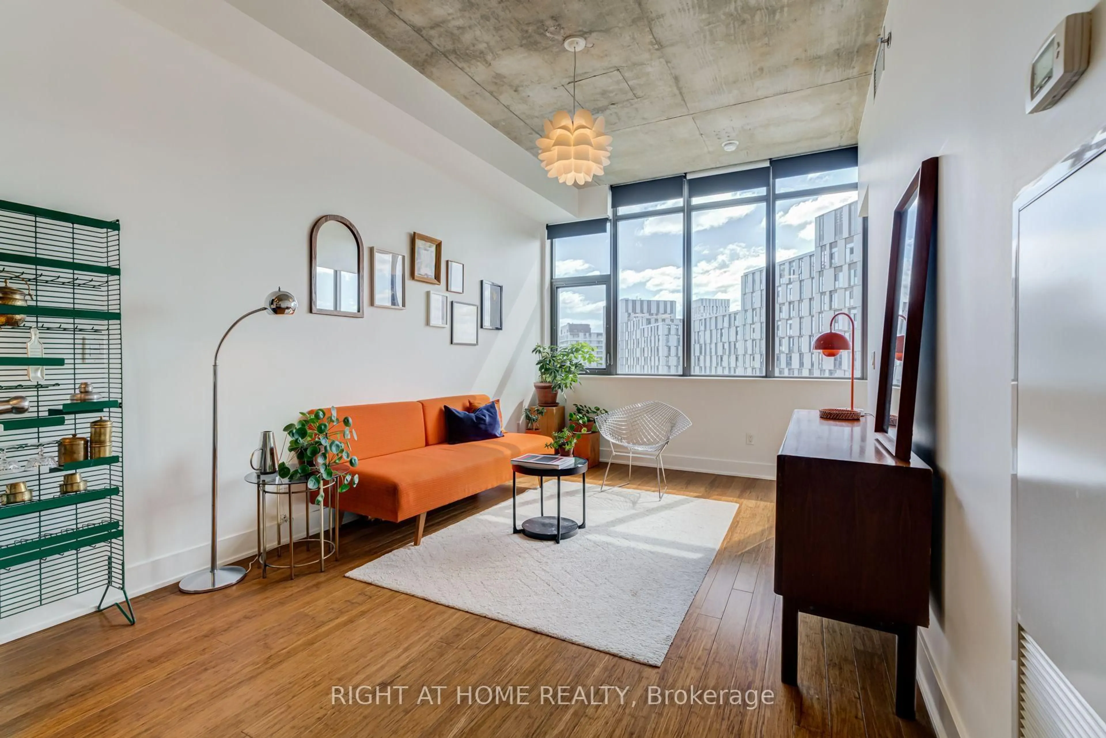 Living room with furniture, cement floor for 90 Trinity St #805, Toronto Ontario M5A 0E4
