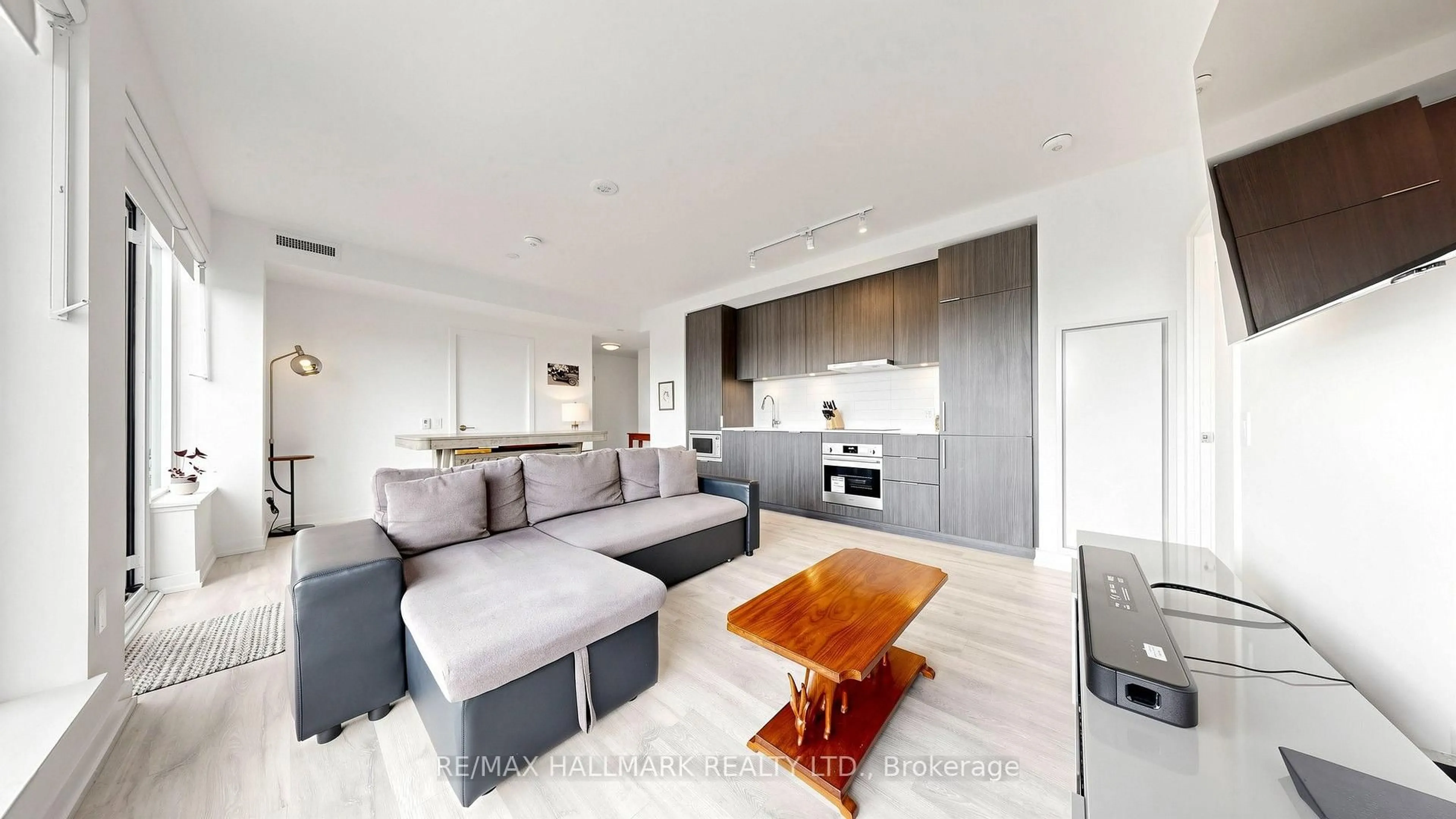 Living room with furniture, wood/laminate floor for 7 Golden Lion Hts #N423, Toronto Ontario M6R 2J3