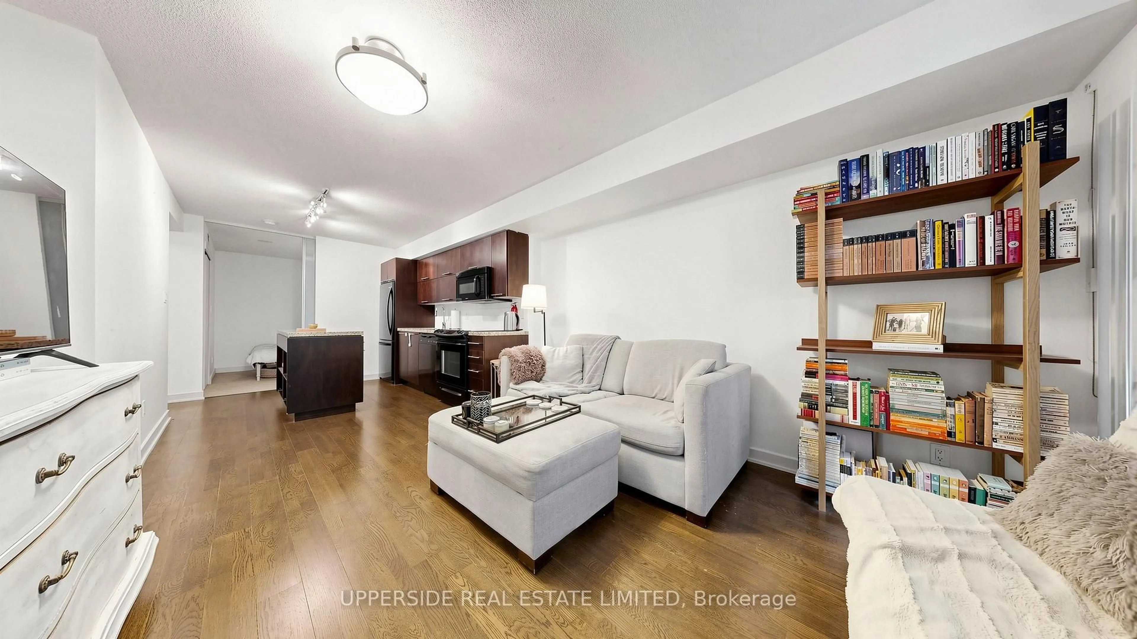 Living room with furniture, wood/laminate floor for 126 Simcoe St #607, Toronto Ontario M5H 4E6