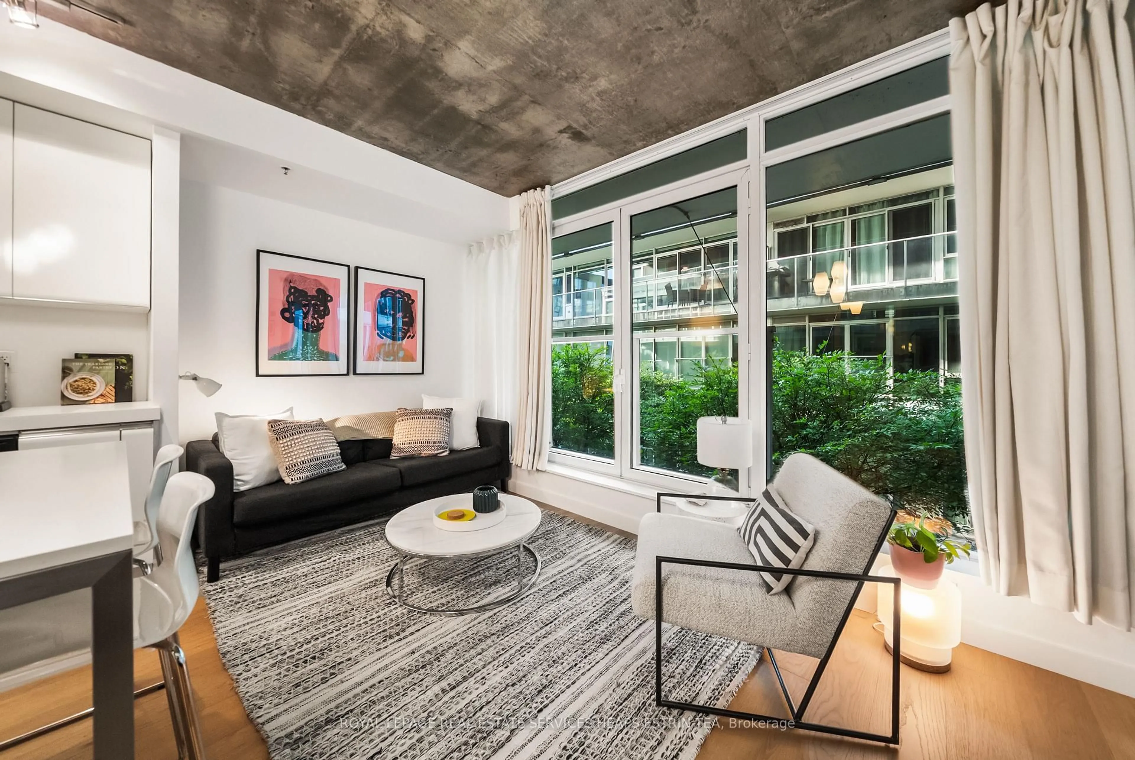 Living room with furniture, cement floor for 75 Portland St #205, Toronto Ontario M5V 2M9