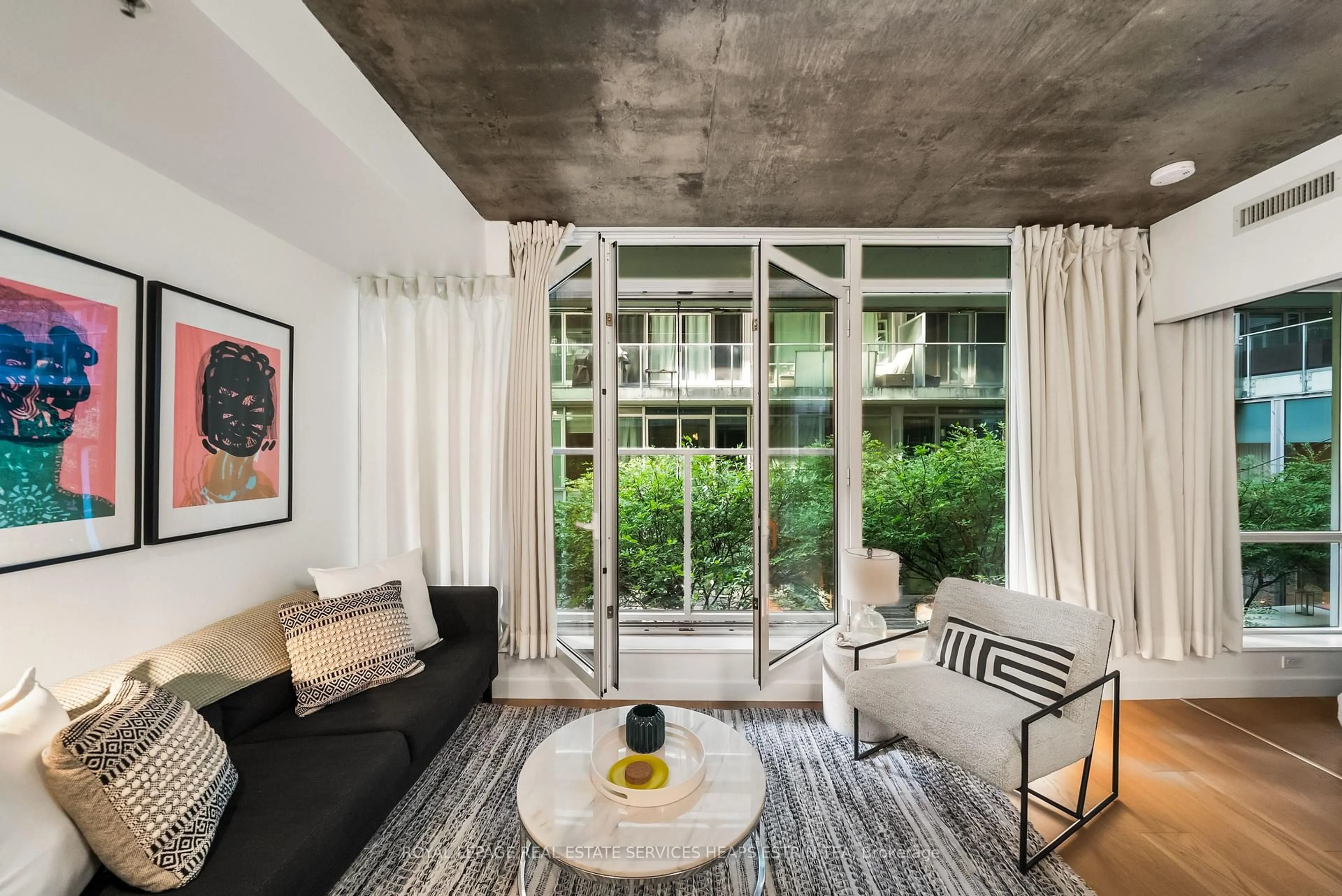 Living room with furniture, cement floor for 75 Portland St #205, Toronto Ontario M5V 2M9