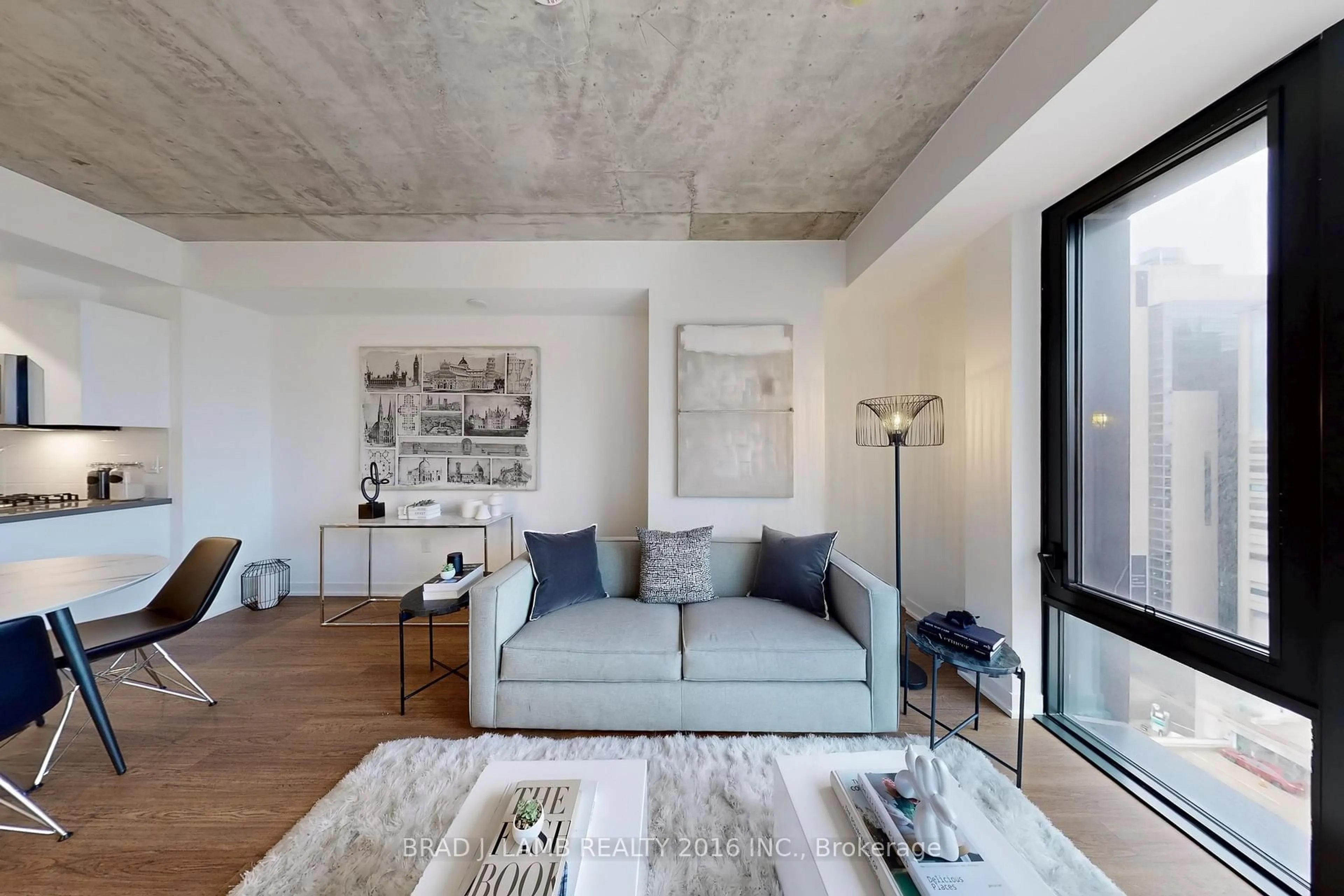 Living room with furniture, cement floor for 195 McCaul St #1403, Toronto Ontario M5T 0E5