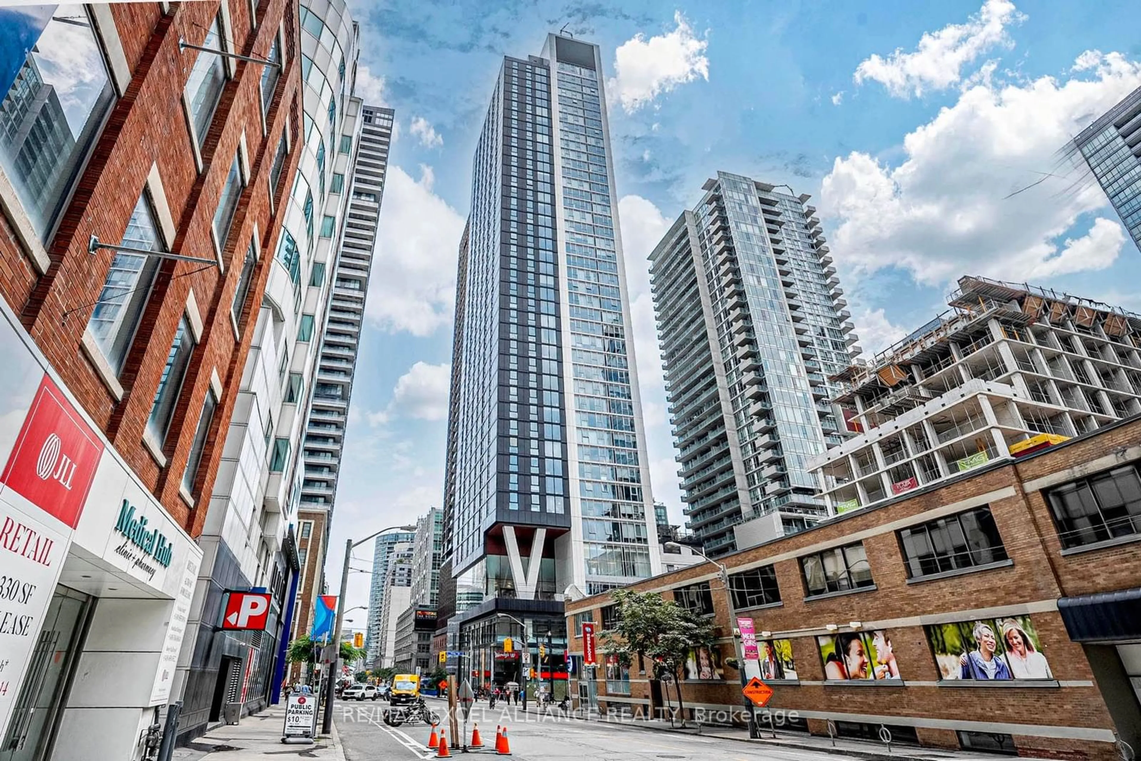 A pic from exterior of the house or condo, the view of city buildings for 357 King St #202, Toronto Ontario M5V 0S7