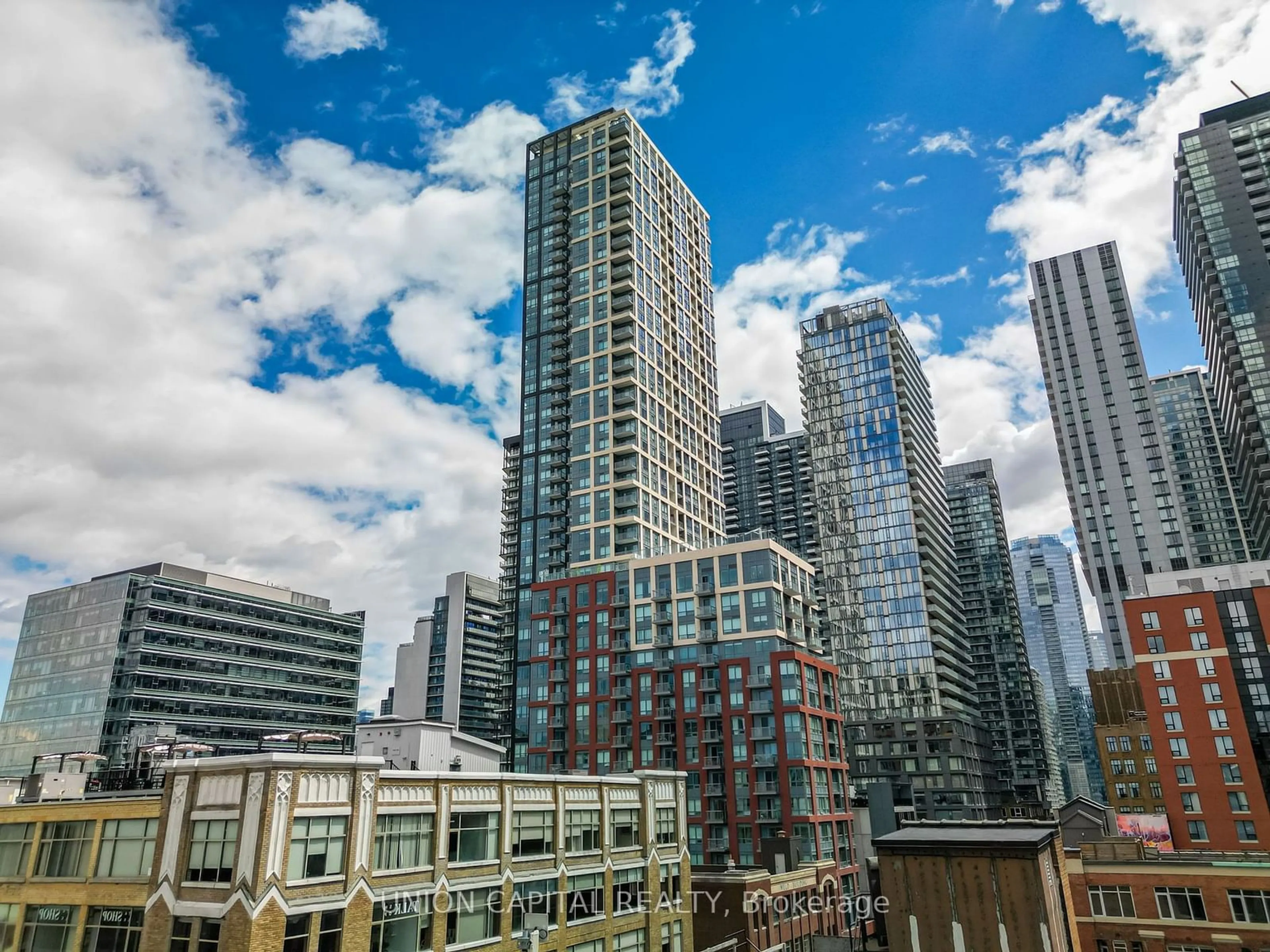 A pic from exterior of the house or condo, the view of city buildings for 108 Peter St #301, Toronto Ontario M5V 0W2