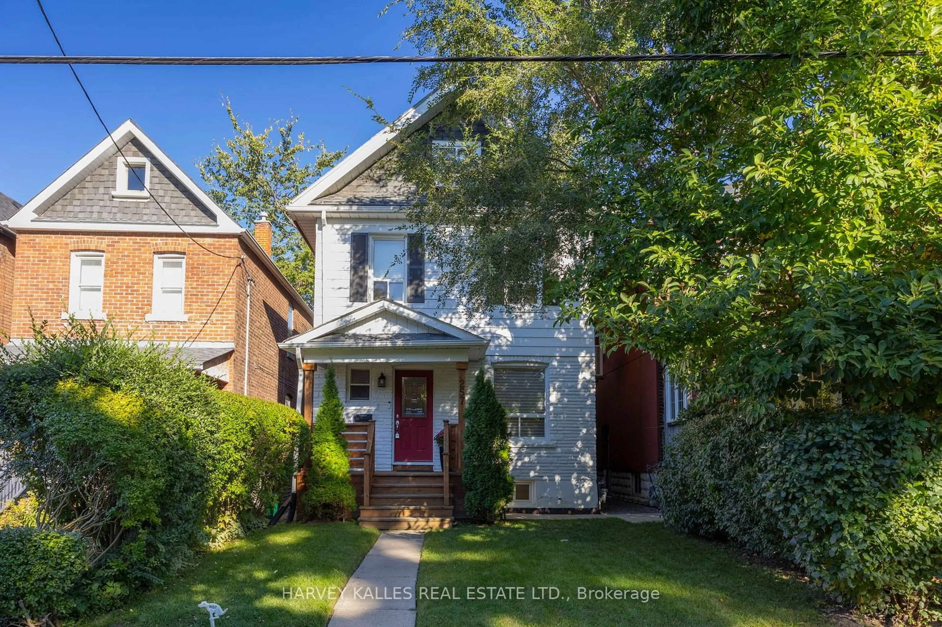 Frontside or backside of a home, the street view for 257 Wychwood Ave, Toronto Ontario M6C 2T6