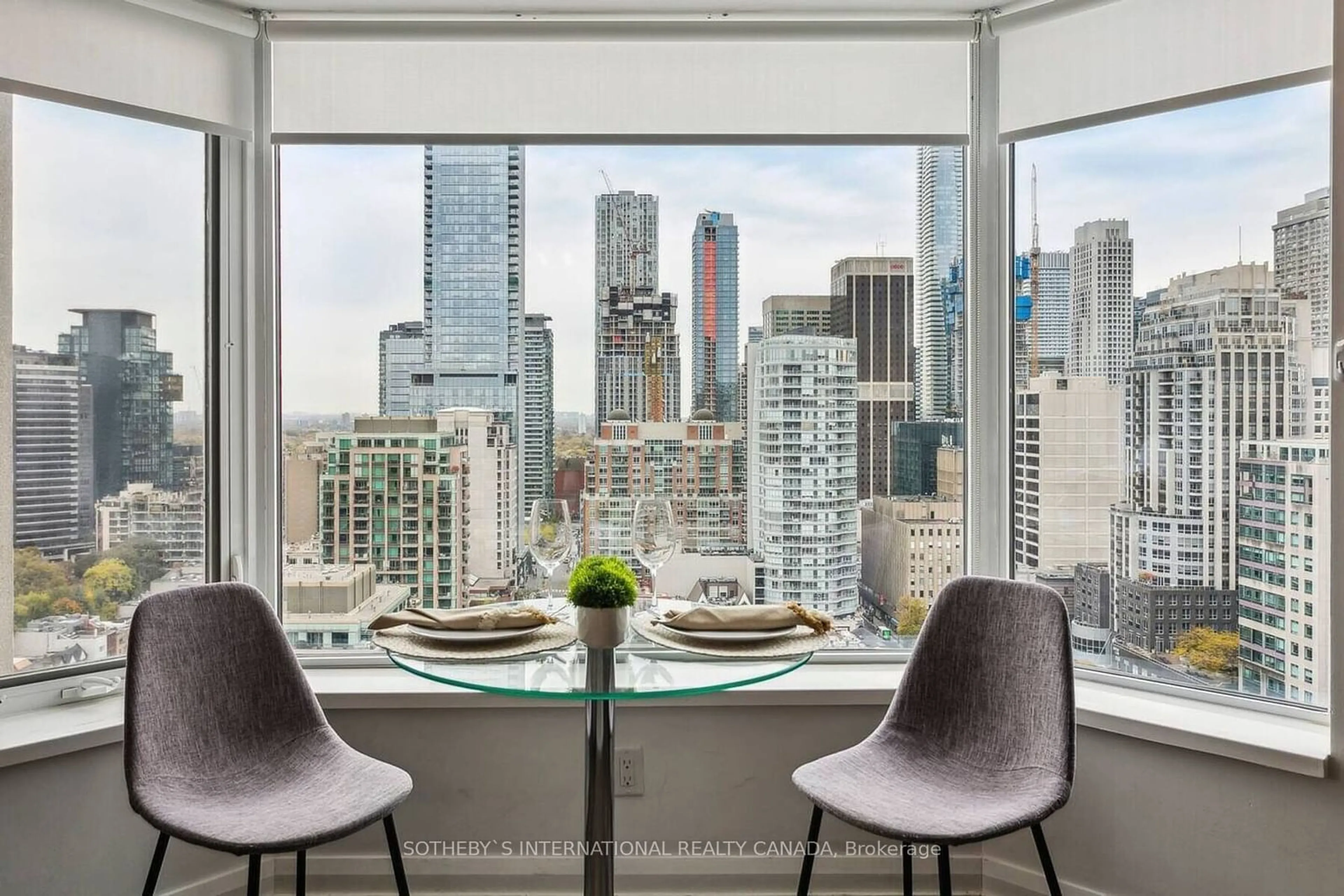 Dining room, wood floors, the view of city buildings for 155 Yorkville Ave #2304, Toronto Ontario M5R 0B4