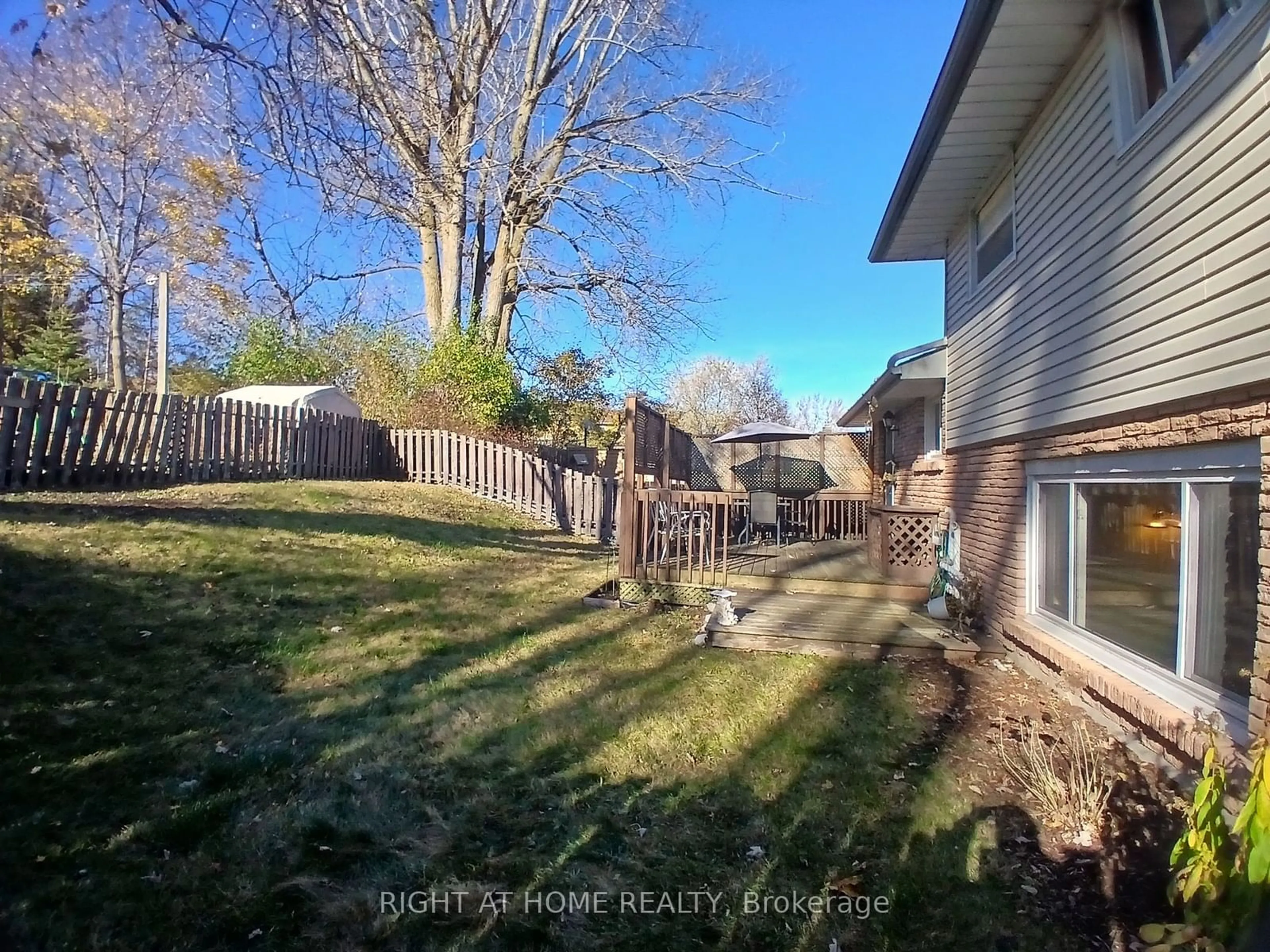 Frontside or backside of a home, the fenced backyard for 22 Orchard Rd, Scugog Ontario L9L 1G4